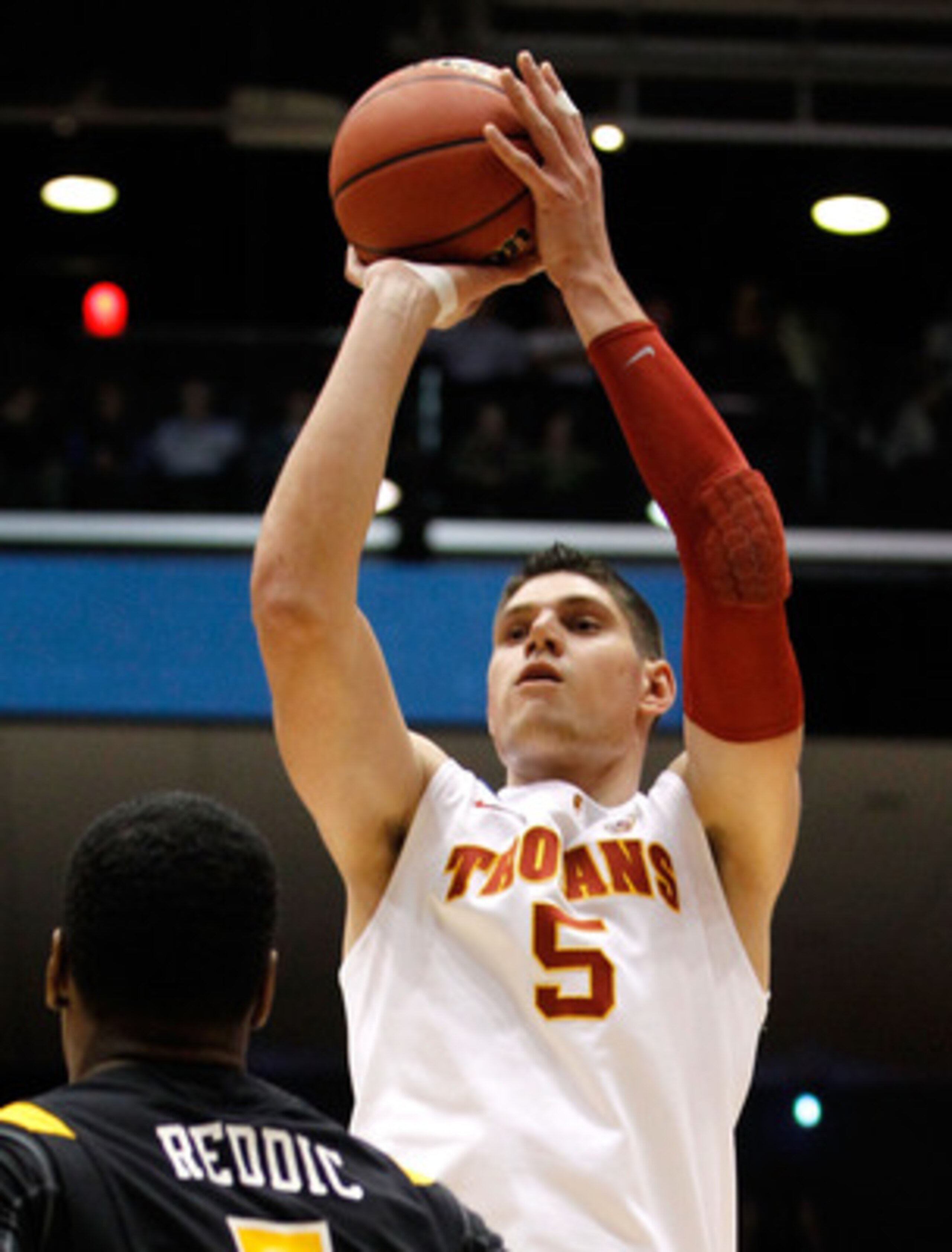 DAYTON, OH - MARCH 16: Nikola Vucevic #5 of the USC Trojans shoots over Juvonte Reddic #5 of the Virginia Commonwealth Rams during the first round of the 2011 NCAA men's basketball tournament at UD Arena on March 16, 2011 in Dayton, Ohio.  (Photo by Grego