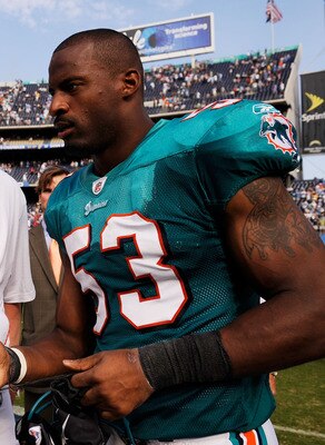 SAN DIEGO - SEPTEMBER 27:  Chad Pennington #10 of the Miami Dolphins, with a right shoulder injury, talks with Reggie Torbor #53 as they walk off the field after the Dolphins lost, 23-13, against the San Diego Chargers during the NFL football game at Qual