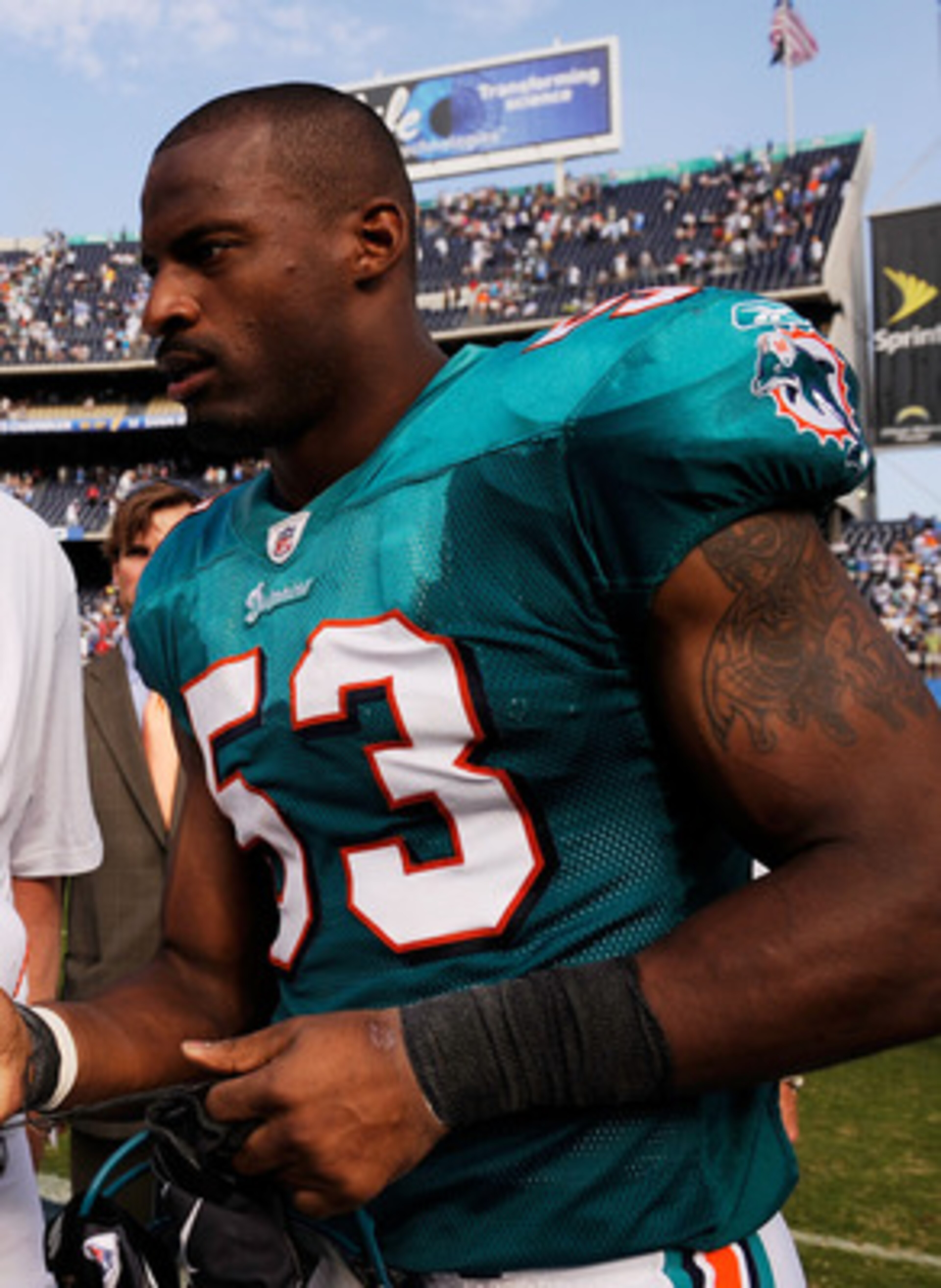 SAN DIEGO - SEPTEMBER 27:  Chad Pennington #10 of the Miami Dolphins, with a right shoulder injury, talks with Reggie Torbor #53 as they walk off the field after the Dolphins lost, 23-13, against the San Diego Chargers during the NFL football game at Qual