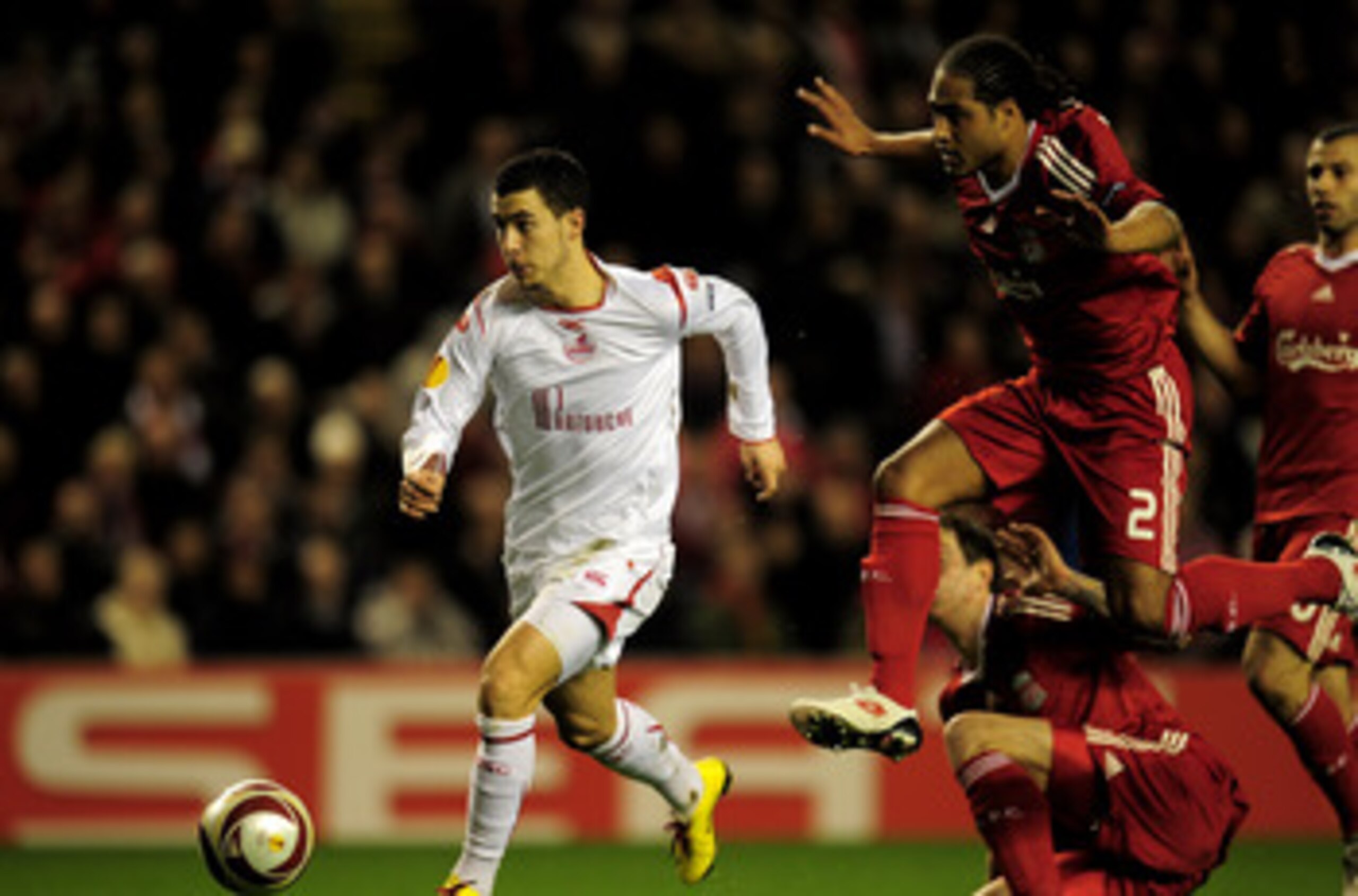 LIVERPOOL, ENGLAND - MARCH 18:  Eden Hazard of Lille breaks clear of the challenge of Glen Johnson of Liverpool during the UEFA Europa League Round of 16, second leg match at Anfield on March 18, 2010 in Liverpool, England.  (Photo by Shaun Botterill/Gett