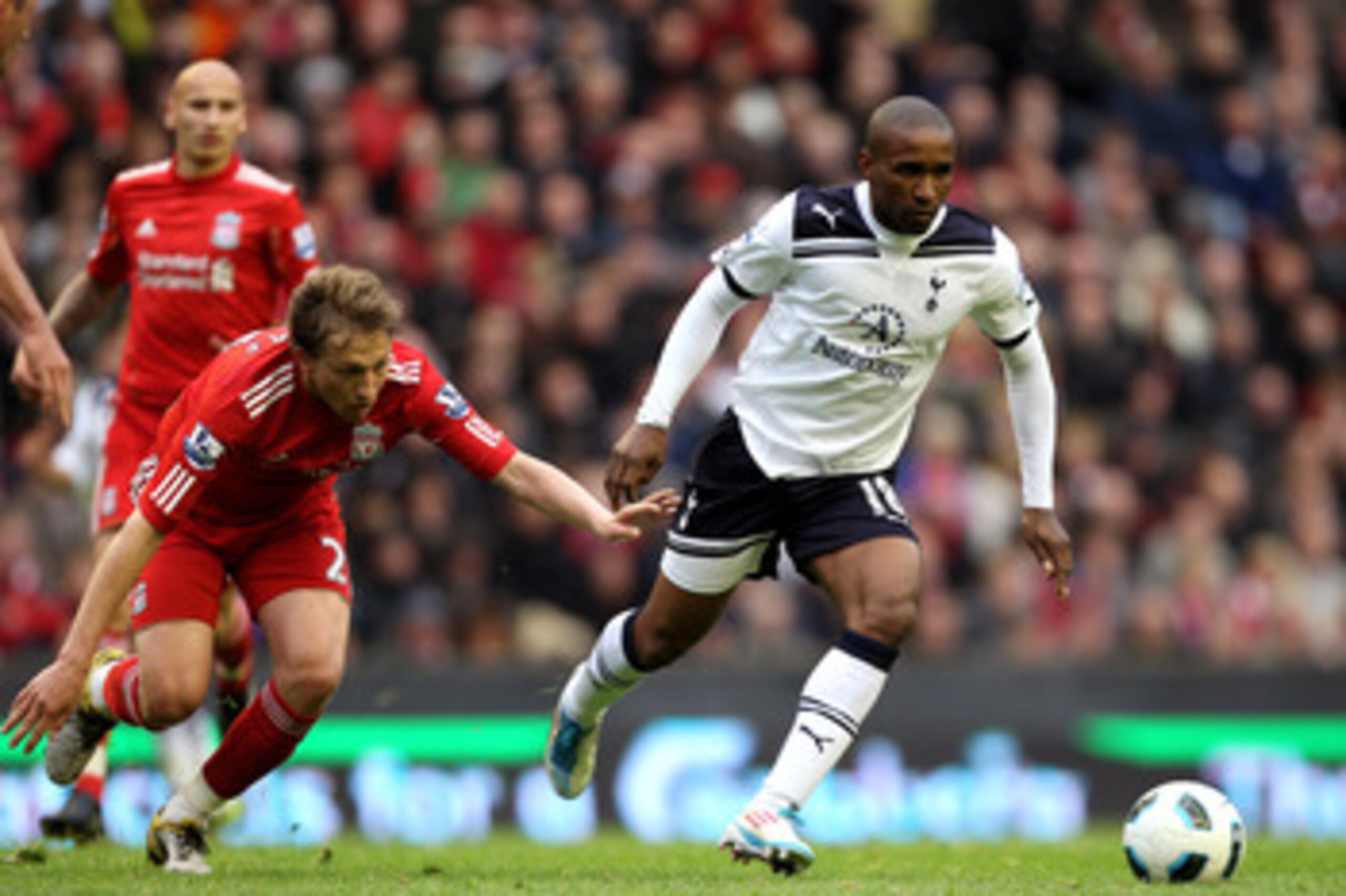 LIVERPOOL, ENGLAND - MAY 15:  Jermain Defoe of Spurs goes past Lucas of Liverpool during the Barclays Premier League match between Liverpool and Tottenham Hotspur at Anfield on May 15, 2011 in Liverpool, England.  (Photo by Michael Steele/Getty Images)