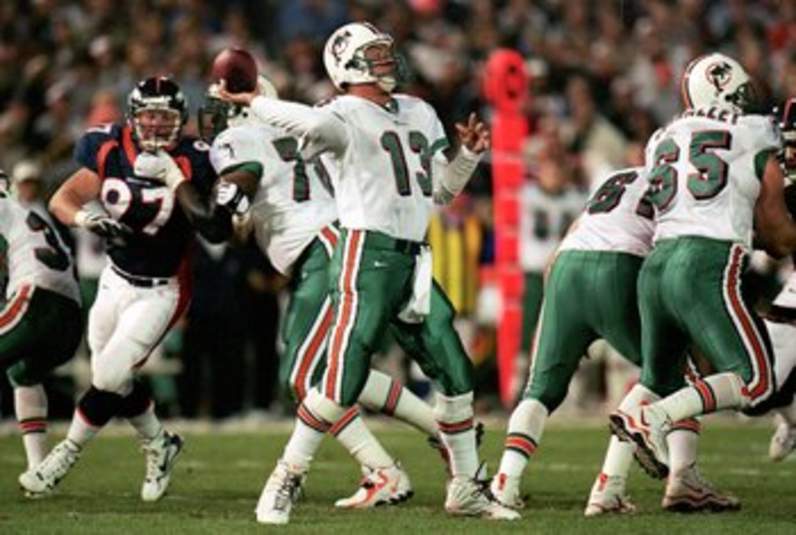 13 Sep 1999: Quarterback Dan Marino #13 of the Miami Dolphins passes the ball during the game against the Denver Broncos at the Mile High Stadium in Denver, Colorado. The Dolphins defeated the Broncos 38-21. Mandatory Credit: Brian Bahr  /Allsport