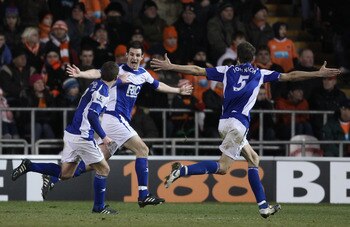 BLACKPOOL, ENGLAND - JANUARY 04:  Scott Dann of Birmingham City celebrates with Roger Johnson and Craig Gardner after scoring the winning goal during the Barclays Premier League match between Blackpool and Birmingham City at Bloomfield Road on January 4, 