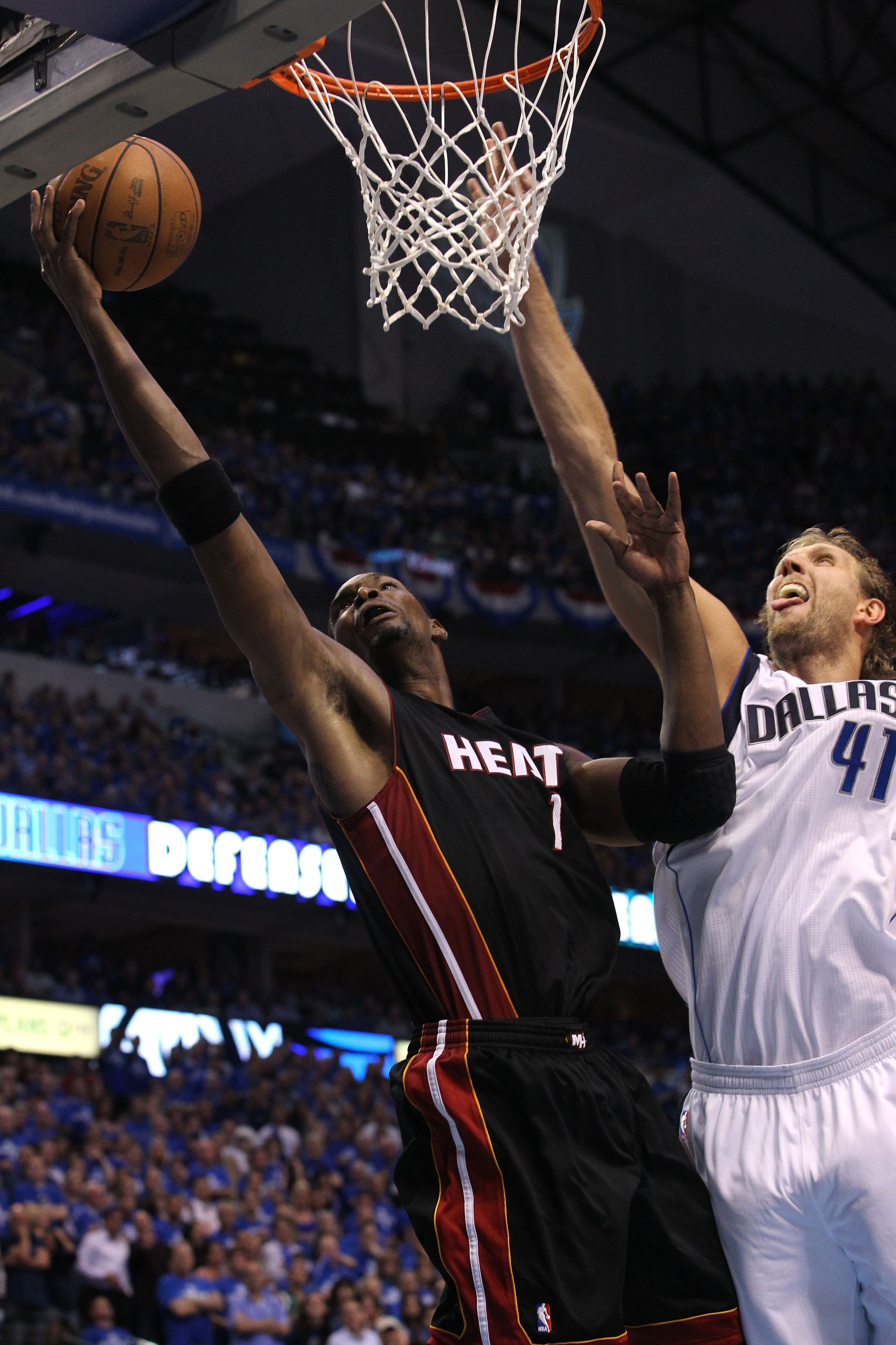 DALLAS, TX - JUNE 09: Chris Bosh #1 of the Miami Heat drives for a shot attempt against Dirk Nowitzki #41 of the Dallas Mavericks in Game Five of the 2011 NBA Finals at American Airlines Center on June 9, 2011 in Dallas, Texas. NOTE TO USER: User expres DALLAS, TX - JUNE 09: Chris Bosh #1 of the Miami Heat drives for a shot attempt against Dirk Nowitzki #41 of the Dallas Mavericks in Game Five of the 2011 NBA Finals at American Airlines Center on June 9, 2011 in Dallas, Texas. NOTE TO USER: User expres