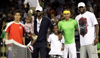 KEY BISCAYNE, FL - MARCH 26:  Miami Heat basketball players Dwyane Wade (2nd from L with sons Zion and Zaire) and LeBron James (R) pose for photo with Kei Nishhikori (L) of Japan and Rafael Nadal of Spain prior to their match during the Sony Ericsson Open