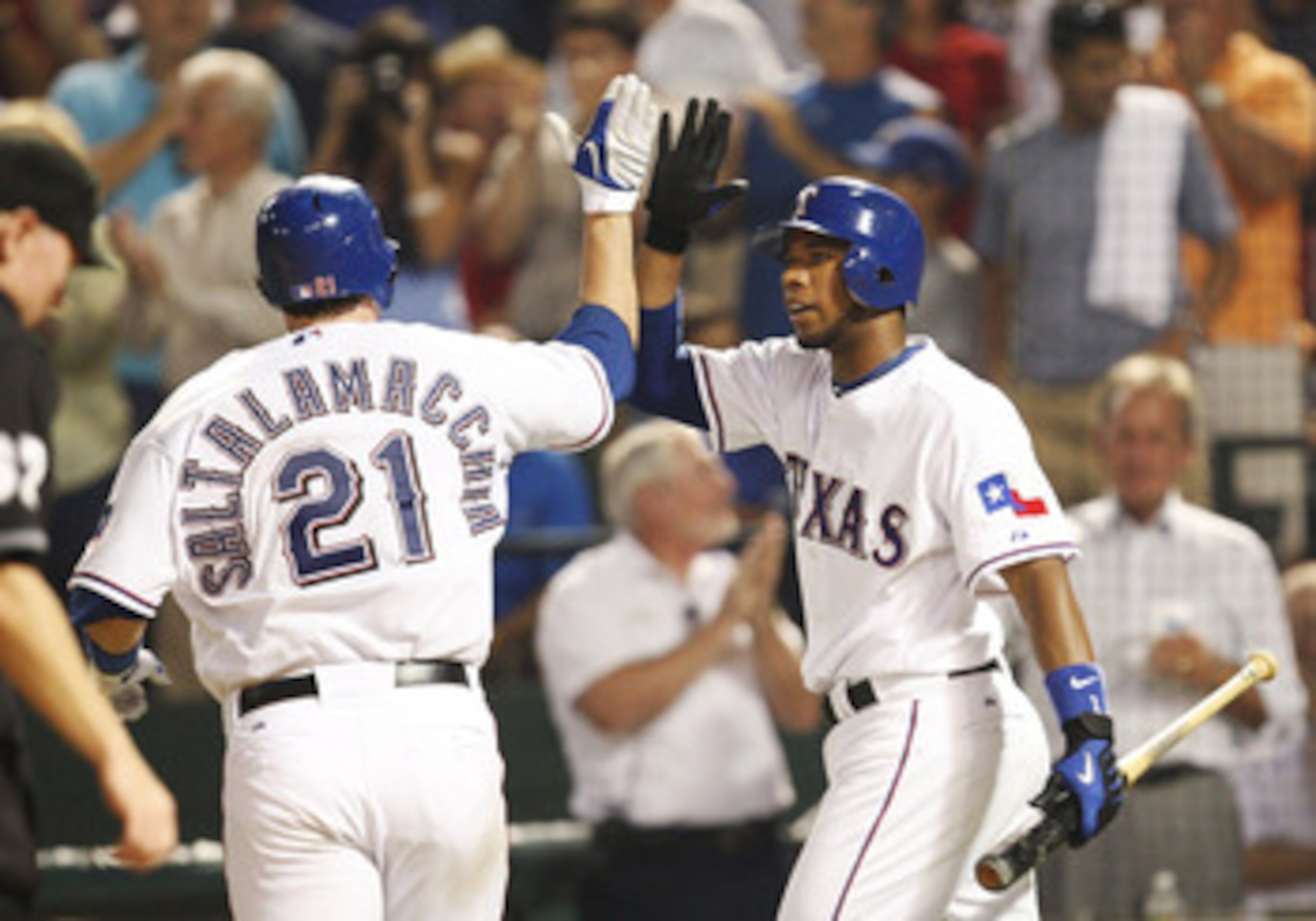 ARLINGTON, TX - JULY 20: Elvis Andrus #1 of the Texas Rangers celebrates with a high-five with teammate Jarrod Saltalamacchia #21 after Saltalamacchia hit a home run in the sixth inning against pitcher John Smoltz (not in photo) during the MLB game at Ra ARLINGTON, TX - JULY 20: Elvis Andrus #1 of the Texas Rangers celebrates with a high-five with teammate Jarrod Saltalamacchia #21 after Saltalamacchia hit a home run in the sixth inning against pitcher John Smoltz (not in photo) during the MLB game at Ra