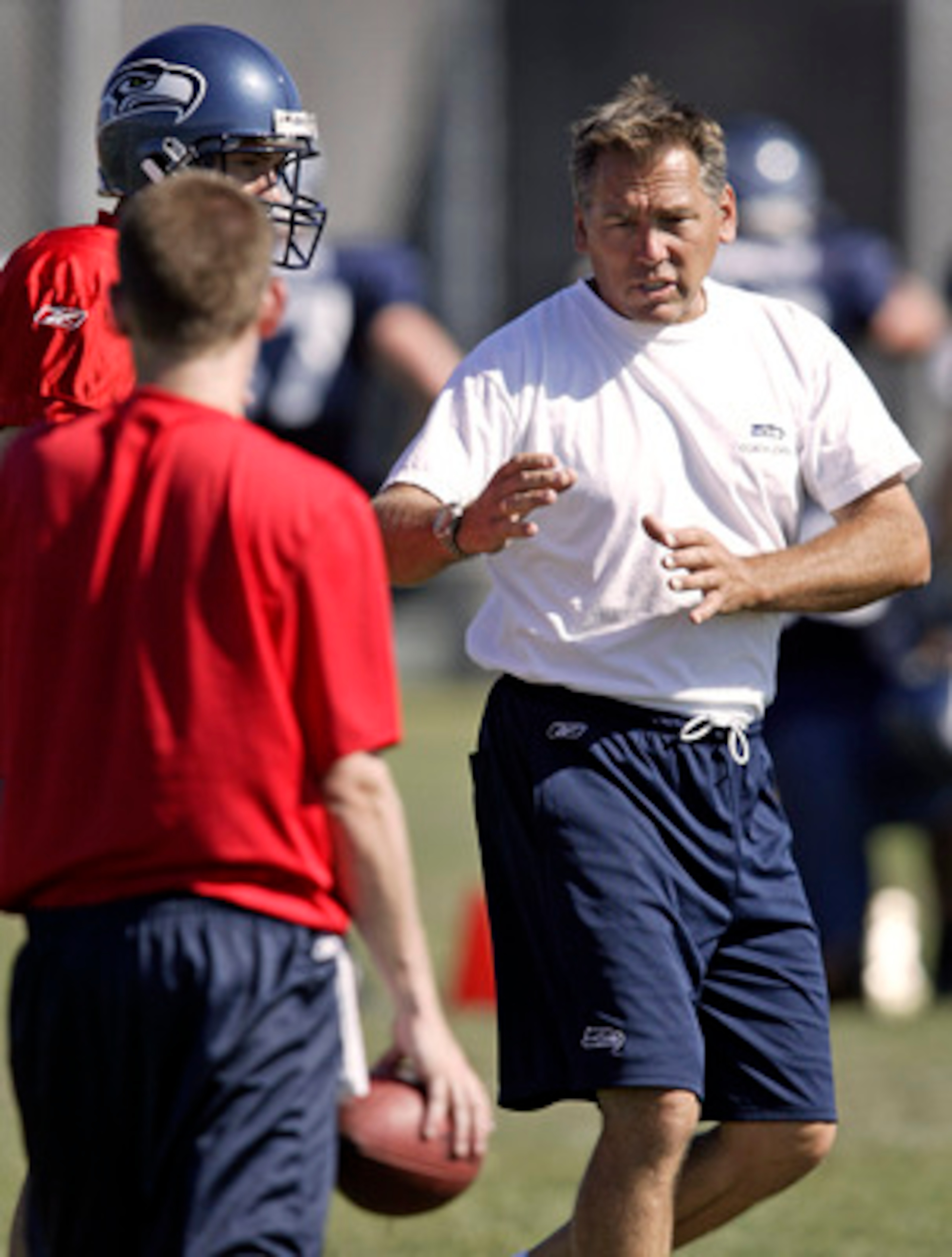 CHENEY, WA - AUGUST 3:  Quarterback coach Jim Zorn (R) of the Seattle Seahawks gives instructions on a play during training camp at Eastern Washington University on August 3, 2005 in Cheney, Washington.  (Photo by Jeff T. Green/Getty Images)