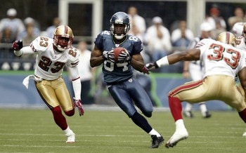 SEATTLE - SEPTEMBER 26:  Wide Receiver Bobby Engram #84 of the Seattle Seahawks rushes for a 59 yard gain against Jimmy Williams #23 and Tony Parrish #33 of the San Francisco 49ers at Qwest Field on September 26, 2004 in Seattle, Washington. (Photo by Ott