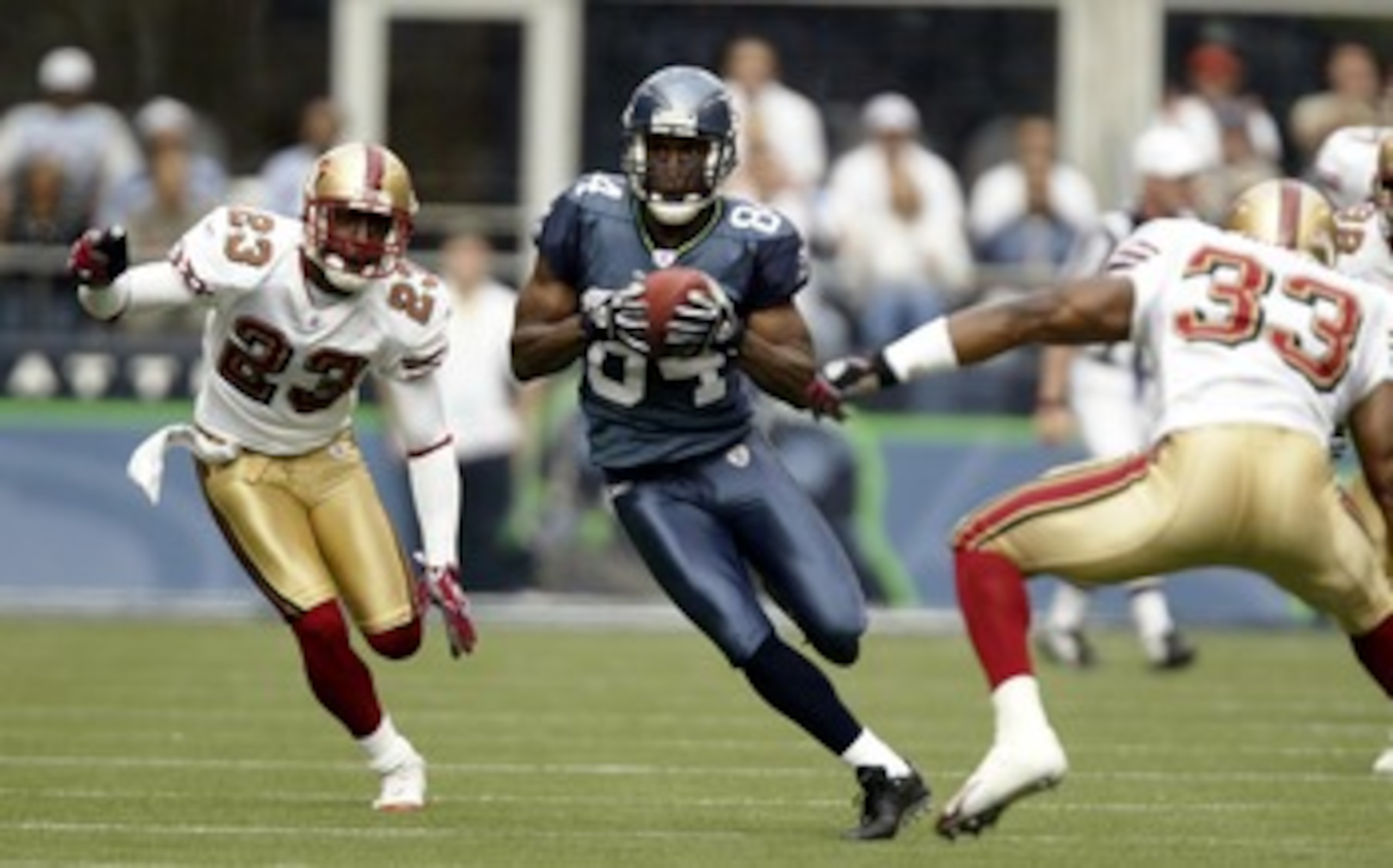 SEATTLE - SEPTEMBER 26: Wide Receiver Bobby Engram #84 of the Seattle Seahawks rushes for a 59 yard gain against Jimmy Williams #23 and Tony Parrish #33 of the San Francisco 49ers at Qwest Field on September 26, 2004 in Seattle, Washington. (Photo by Ott SEATTLE - SEPTEMBER 26: Wide Receiver Bobby Engram #84 of the Seattle Seahawks rushes for a 59 yard gain against Jimmy Williams #23 and Tony Parrish #33 of the San Francisco 49ers at Qwest Field on September 26, 2004 in Seattle, Washington. (Photo by Ott