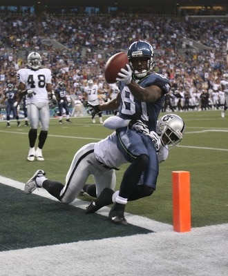SEATTLE - AUGUST 30:  Wide receiver Nate Burleson #81 of the Seattle Seahawks scores a touchdown against Hiram Eugene #31 of the Oakland Raiders in a preseason game at Qwest Field August 30, 2007 in Seattle, Washington. (Photo by Otto Greule Jr/Getty Imag