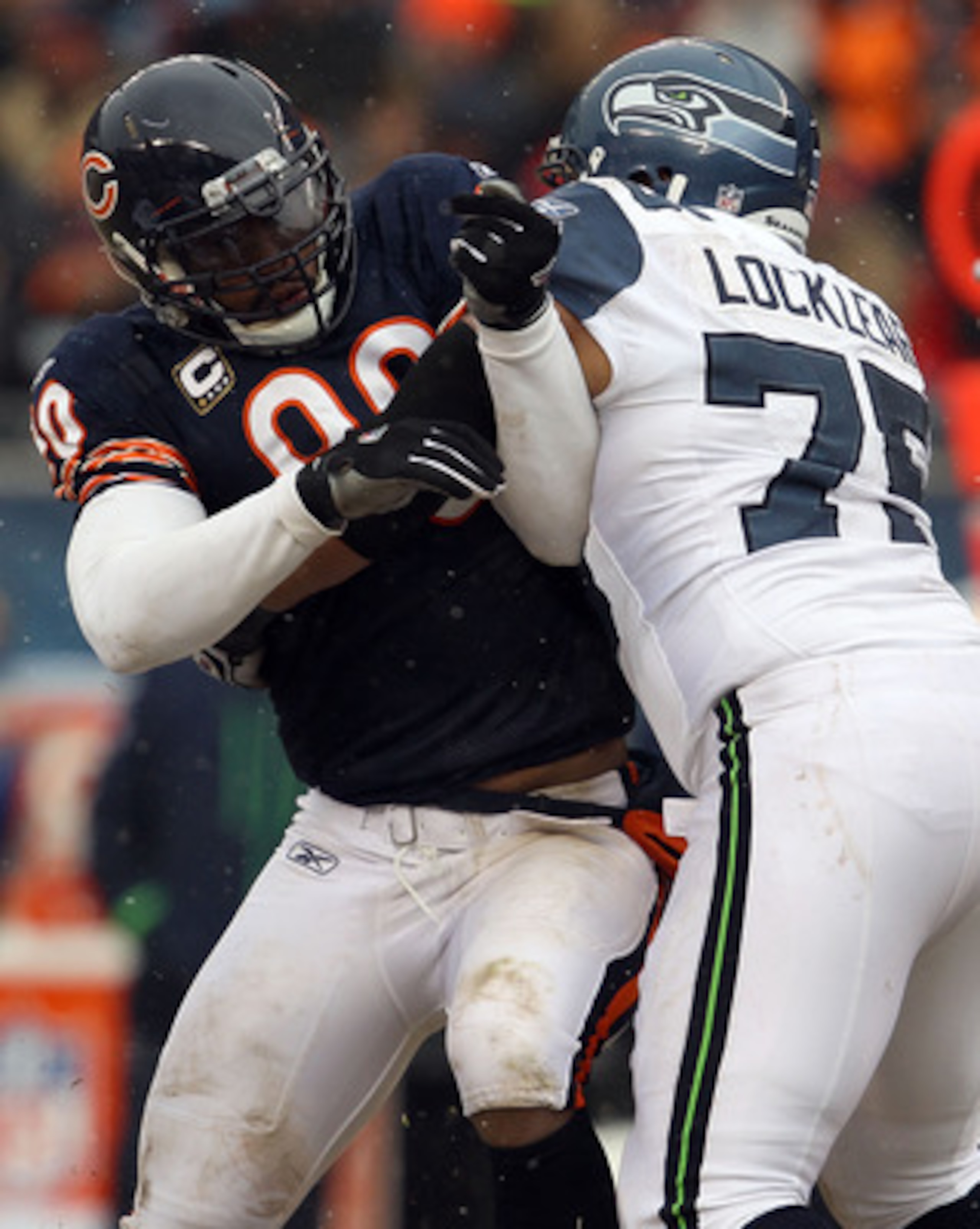 CHICAGO, IL - JANUARY 16: Julius Peppers #90 of the Chicago Bears is blocked by Sean Locklear #75 of the Seattle Seahawks in the 2011 NFC divisional playoff game at Soldier Field on January 16, 2011 in Chicago, Illinois. (Photo by Jonathan Daniel/Getty CHICAGO, IL - JANUARY 16: Julius Peppers #90 of the Chicago Bears is blocked by Sean Locklear #75 of the Seattle Seahawks in the 2011 NFC divisional playoff game at Soldier Field on January 16, 2011 in Chicago, Illinois. (Photo by Jonathan Daniel/Getty