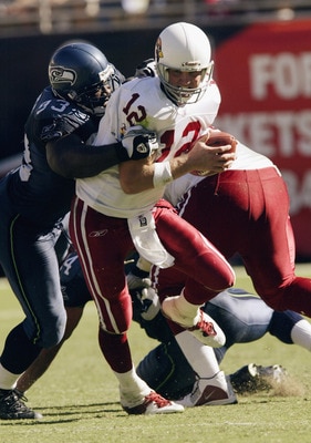 TEMPE, AZ - SEPTEMBER 14:  Quarterback Josh McCown #12 of the Arizona Cardinals is brought down by defensive tackle John Randle #93 of the Seattle Seahawks on September 14, 2003 at Sun Devil Stadium in Tempe, Arizona.  The Seahawks defeated the Cardinals