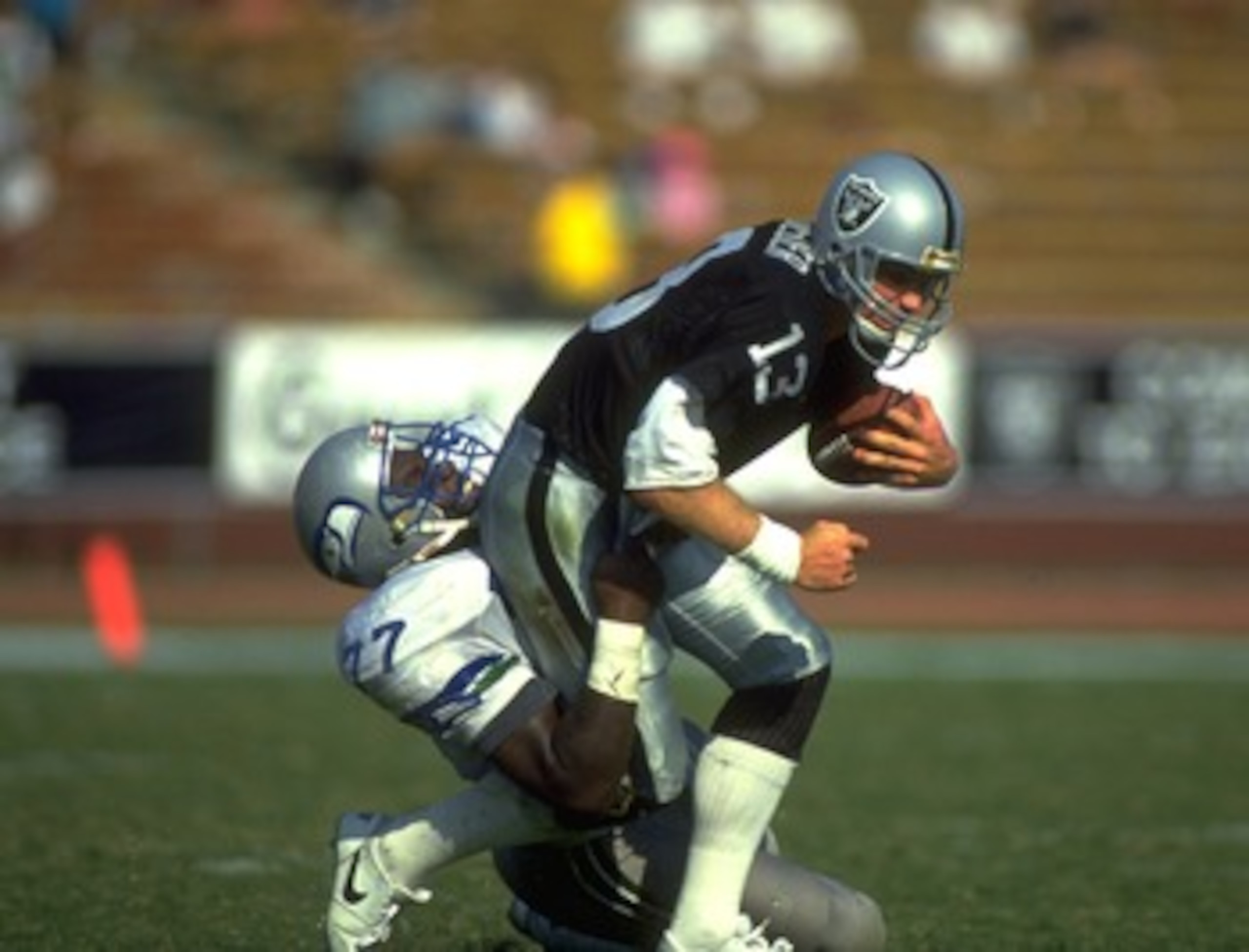 14 OCT 1990: SEATTLE SEAHAWKS DEFENSIVE LINEMAN JEFF BRYANT (LEFT) SACKS LOS ANGELES RAIDERS QUARTERBACK JAY SCHROEDER DURING THE SEAHAWKS 24-17 LOSS AT THE MEMORIAL COLISEUM IN LOS ANGELES, CALIFORNIA. 14 OCT 1990: SEATTLE SEAHAWKS DEFENSIVE LINEMAN JEFF BRYANT (LEFT) SACKS LOS ANGELES RAIDERS QUARTERBACK JAY SCHROEDER DURING THE SEAHAWKS 24-17 LOSS AT THE MEMORIAL COLISEUM IN LOS ANGELES, CALIFORNIA.