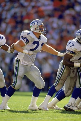 DENVER - SEPTEMBER 23:  Guard Bryan Millard #71 of the Seattle Seahawks moves down the line to make a block against the Denver Broncos on September 23, 1990 at Mile High Stadium in Denver, Colorado. The Broncos beat the Seahawks 34-31 in overtime. (Photo