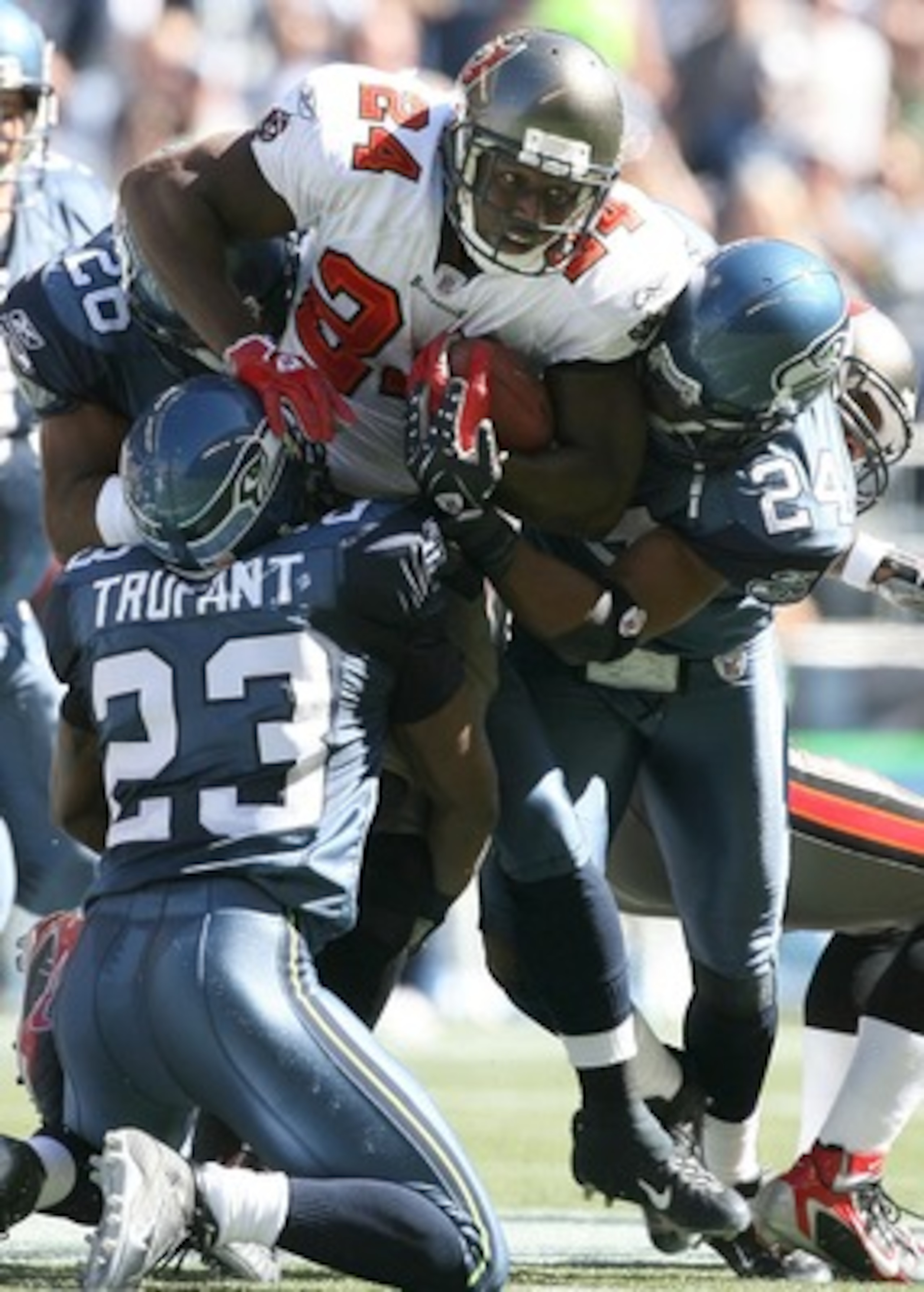 SEATTLE - SEPTEMBER 09: Running back Carnell Williams #24 of the Tampa Bay Buccaneers rushes against Marcus Trufant #23 and Deon Grant #24 of the Seattle Seahawks at Qwest Field on September 9, 2007 in Seattle, Washington. The Seahawks defeated the Bucc SEATTLE - SEPTEMBER 09: Running back Carnell Williams #24 of the Tampa Bay Buccaneers rushes against Marcus Trufant #23 and Deon Grant #24 of the Seattle Seahawks at Qwest Field on September 9, 2007 in Seattle, Washington. The Seahawks defeated the Bucc