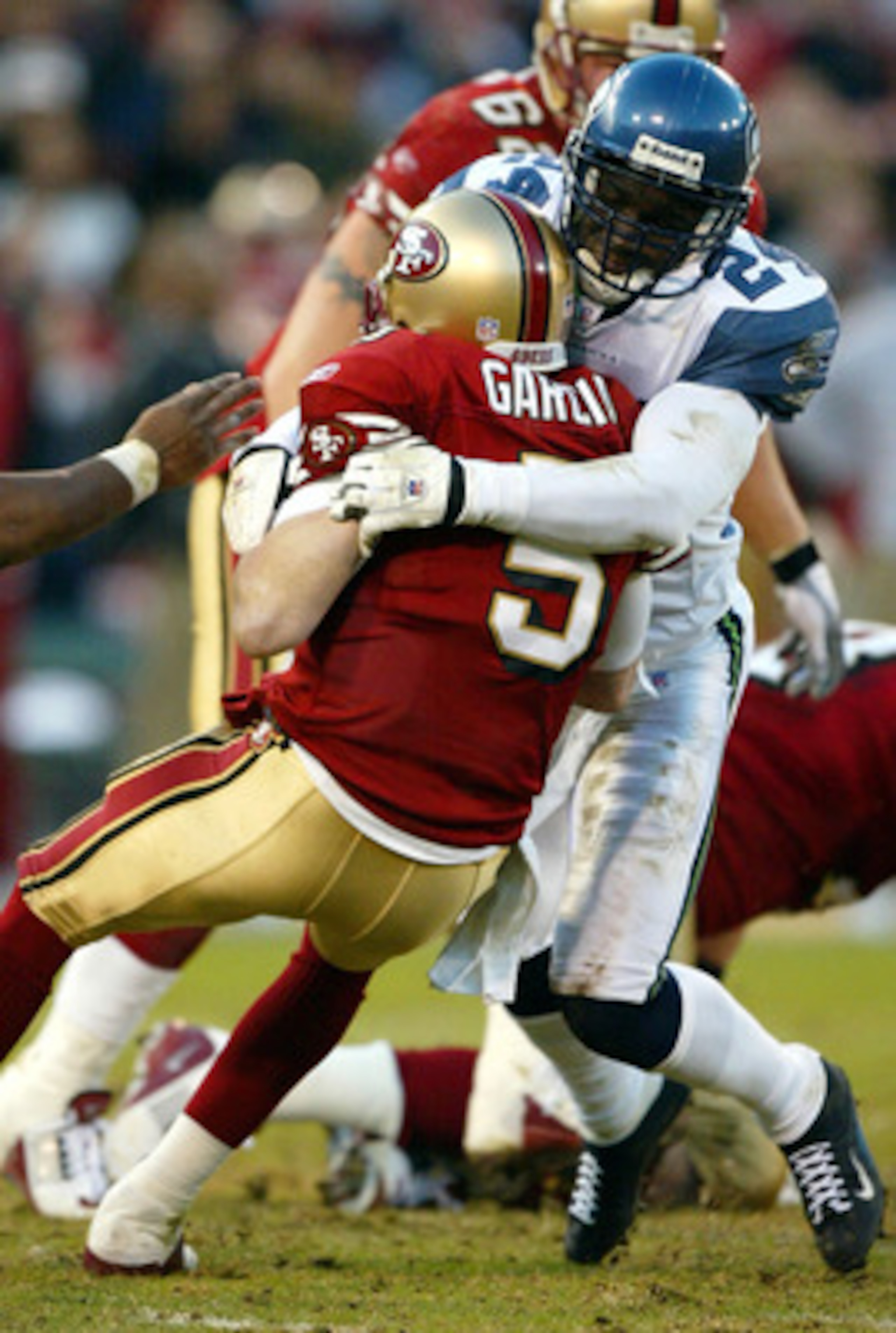 SAN FRANCISCO - DECEMBER 27: Shawn Springs #24 of the Seattle Seahawks sacks quarterback Jeff Garcia #5 of the San Francisco 49ers during an NFL game on December 27, 2003 at Candlestick Park in San Francisco, California. (Photo by Jed Jacobsohn/Getty Im SAN FRANCISCO - DECEMBER 27: Shawn Springs #24 of the Seattle Seahawks sacks quarterback Jeff Garcia #5 of the San Francisco 49ers during an NFL game on December 27, 2003 at Candlestick Park in San Francisco, California. (Photo by Jed Jacobsohn/Getty Im