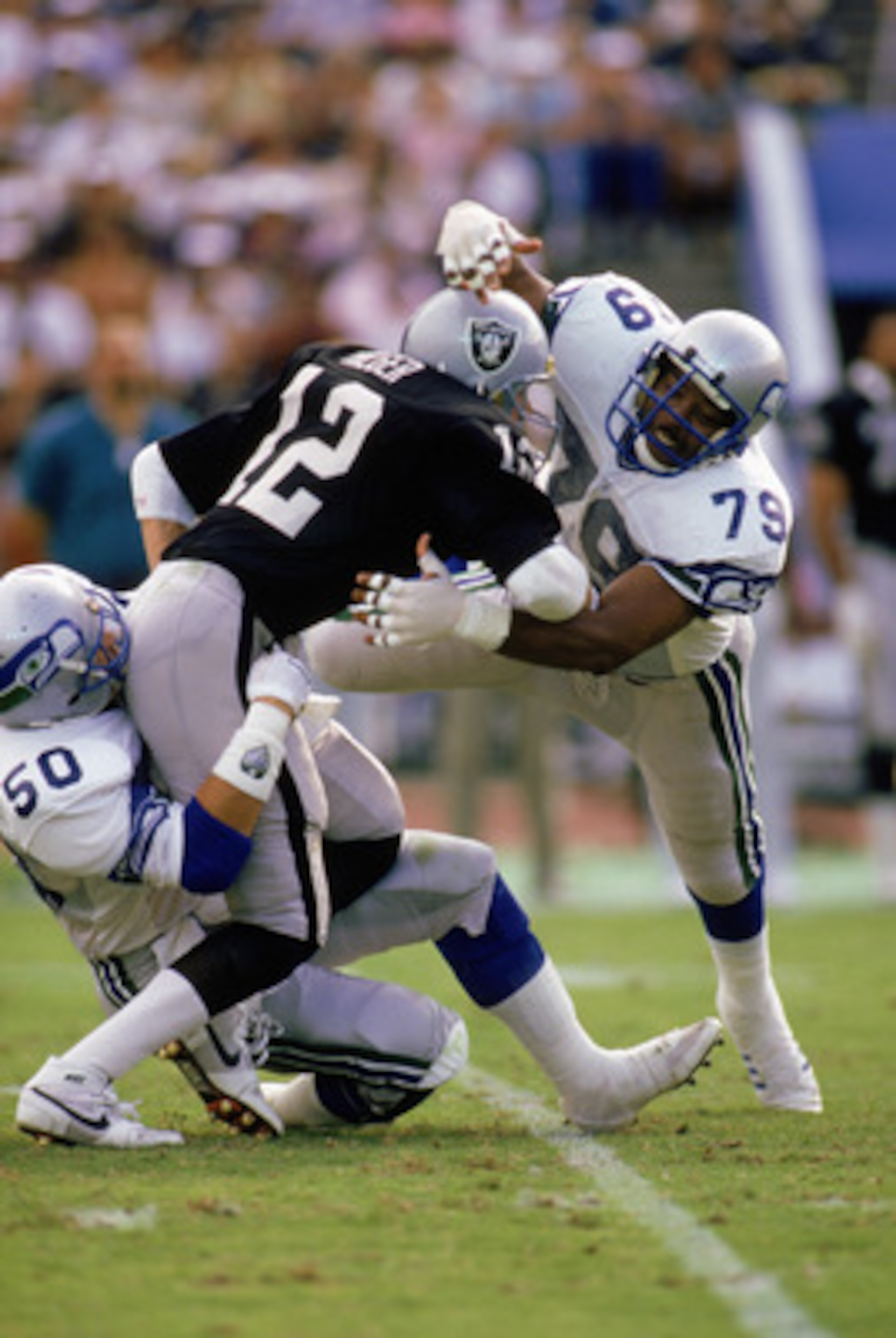 LOS ANGELES - DECEMBER 18: Defensive end Jacob Green #79 of the Seattle Seahawks tackles a Los Angeles Raiders player on December 18, 1988 in the Los Angeles Coliseum in Los Angeles, California. The Seahawks won 43-37. (Photo by Rick Stewart/Getty Image LOS ANGELES - DECEMBER 18: Defensive end Jacob Green #79 of the Seattle Seahawks tackles a Los Angeles Raiders player on December 18, 1988 in the Los Angeles Coliseum in Los Angeles, California. The Seahawks won 43-37. (Photo by Rick Stewart/Getty Image