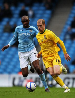 MANCHESTER, ENGLAND - FEBRUARY 20:  Neil Bishop of Notts County is challenged by Patrick Vieira of Manchester City during the FA Cup sponsored by E.On 4th Round replay match between Manchester City and Notts County at City of Manchester Stadium on Februar
