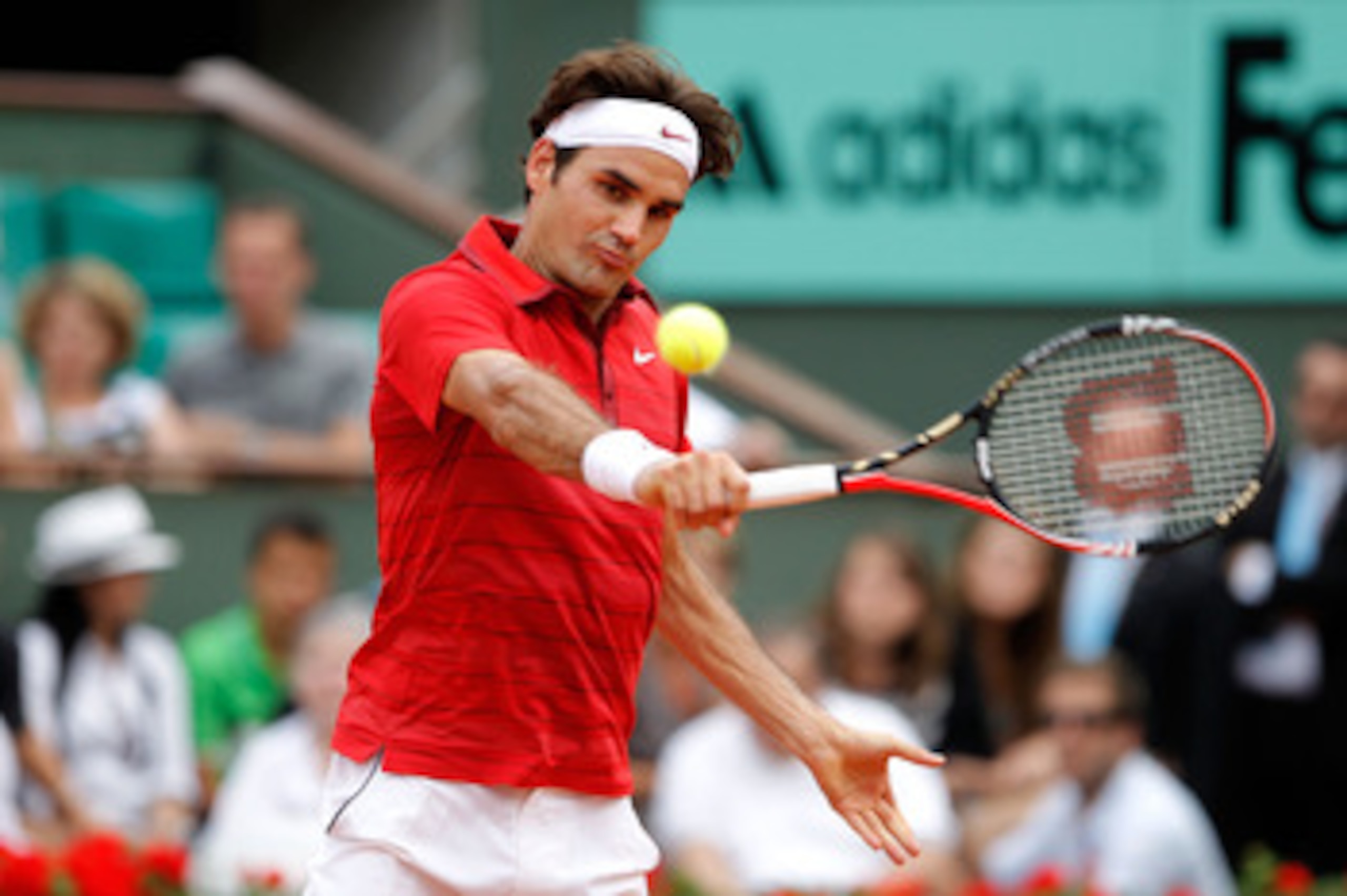 PARIS, FRANCE - JUNE 05:  Roger Federer of Switzerland hits a backhand during the men's singles final match between Rafael Nadal of Spain and Roger Federer of Switzerland on day fifteen of the French Open at Roland Garros on June 5, 2011 in Paris, France.