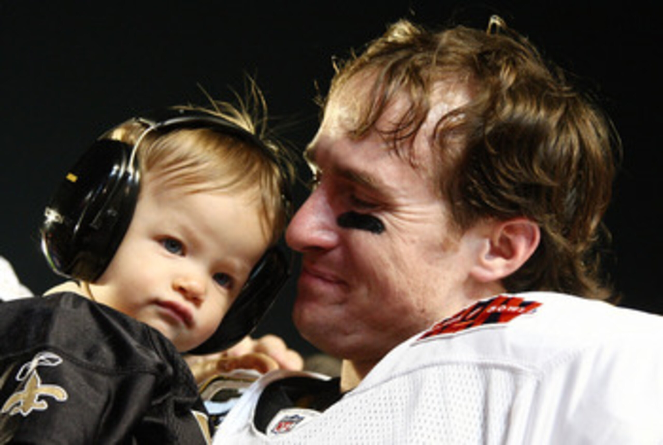MIAMI GARDENS, FL - FEBRUARY 07:  Father Drew Brees #9 of the New Orleans Saints celebrates with his son Baylen Brees after defeating the Indianapolis Colts during Super Bowl XLIV on February 7, 2010 at Sun Life Stadium in Miami Gardens, Florida.  (Photo