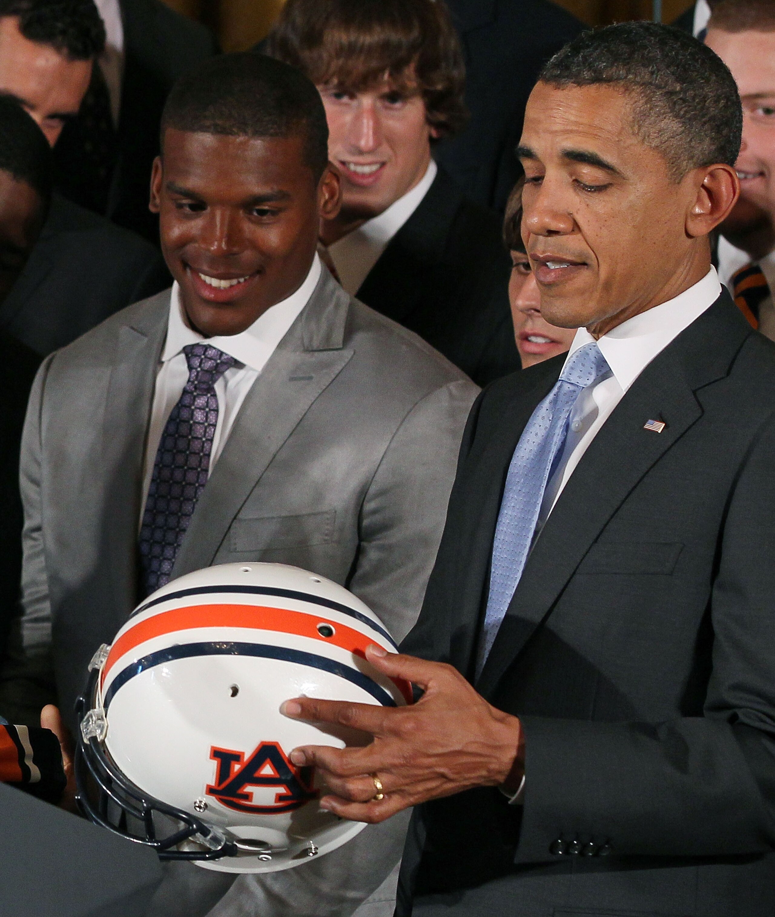 WASHINGTON, DC - JUNE 08: President Barack Obama (R) holds an Auburn Tigers helmet given to him by members of the 2011 BCS National Champion Auburn University football team including Heisman Trophy winner Cameron 'Cam' Newton in the East Room at the White WASHINGTON, DC - JUNE 08: President Barack Obama (R) holds an Auburn Tigers helmet given to him by members of the 2011 BCS National Champion Auburn University football team including Heisman Trophy winner Cameron 'Cam' Newton in the East Room at the White