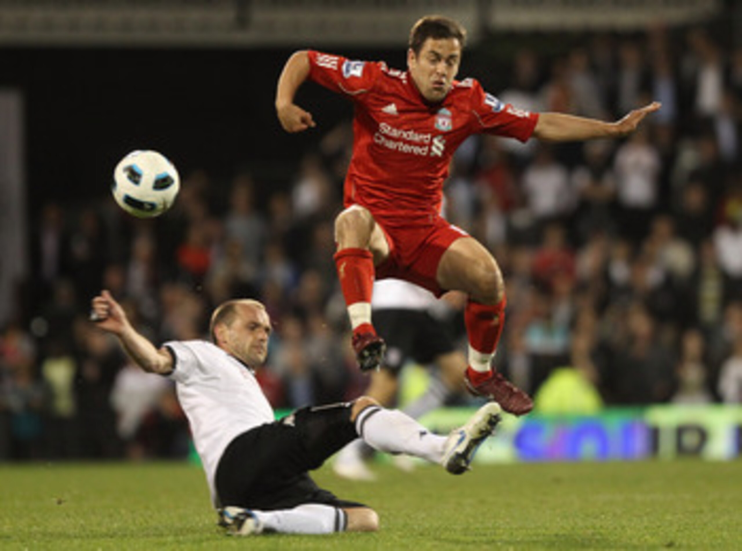 LONDON, ENGLAND - MAY 09: Danny Murphy of Fulham tackles Joe Cole of Liverpool during the Barclays Premier League match between Fulham and Liverpool at Craven Cottage on May 9, 2011 in London, England.  (Photo by Scott Heavey/Getty Images)