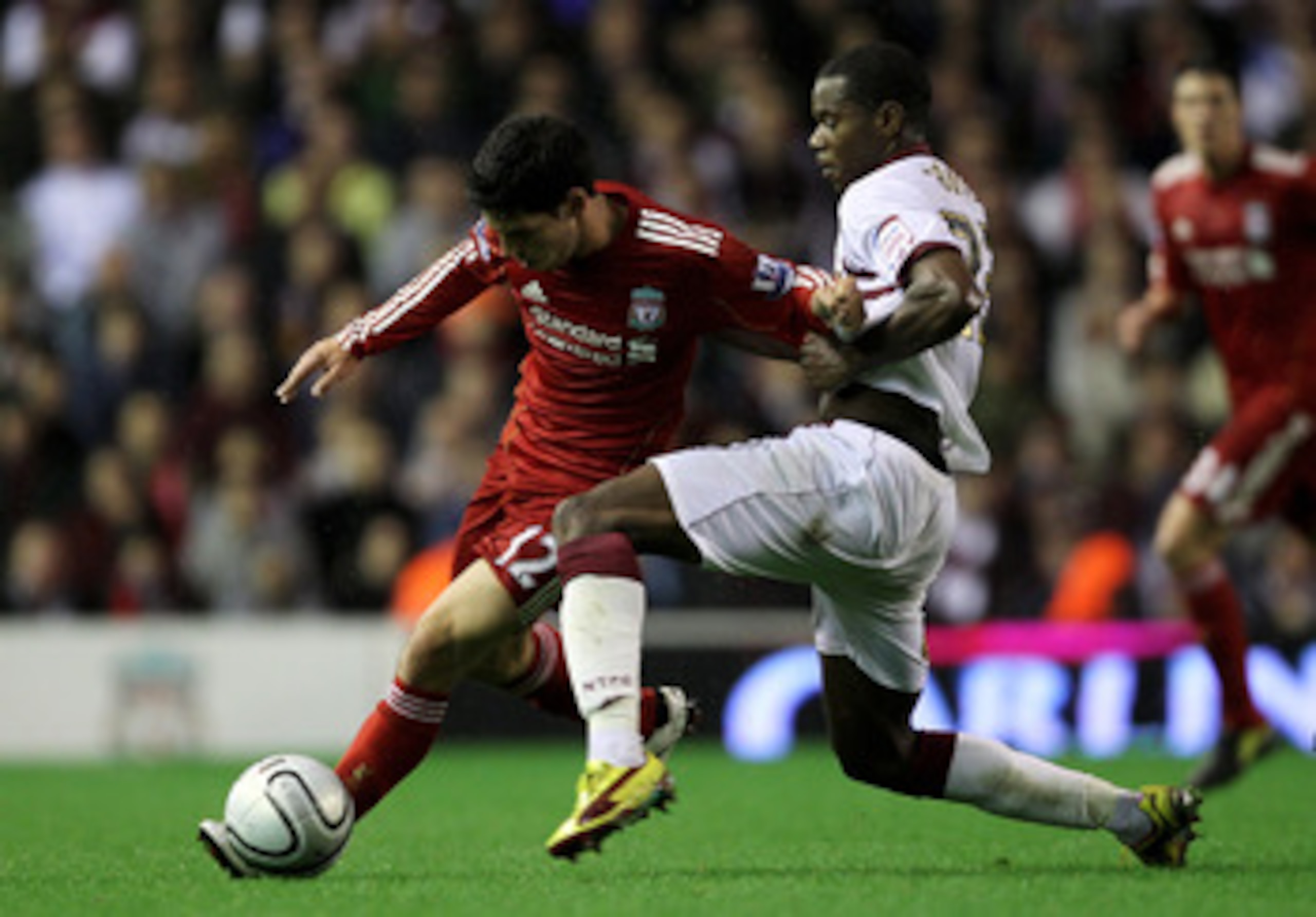 LIVERPOOL, ENGLAND - SEPTEMBER 22:  Daniel Pacheco of Liverpool is challenged by Liam Davis of Northampton Town during the Carling Cup Third Round game between Liverpool and Northampton Town at Anfield on September 22, 2010 in Liverpool, England. (Photo b