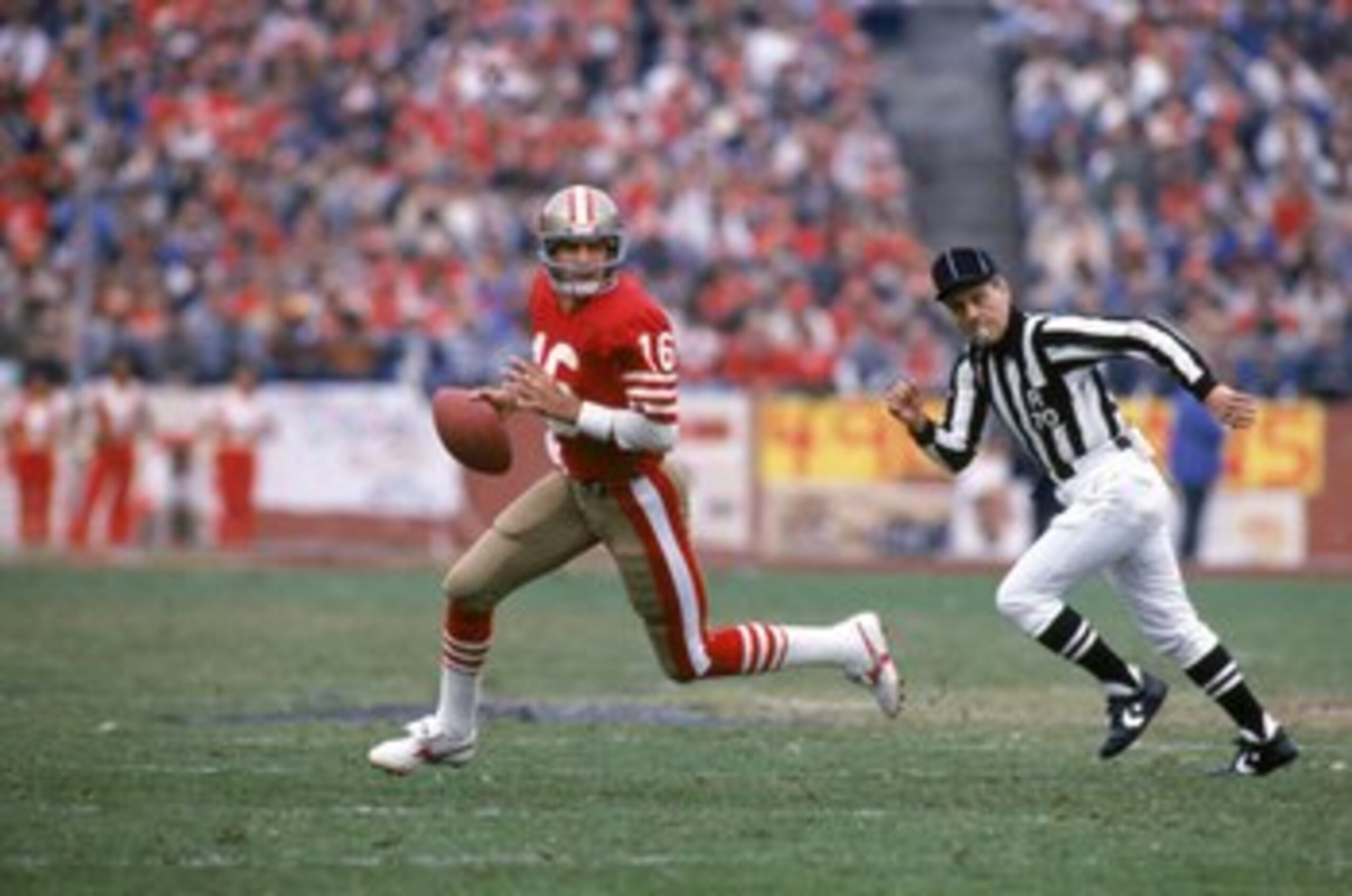 SAN FRANCISCO - JANUARY 6:  Quarterback Joe Montana #16 of the San Francisco 49ers runs with the ball as he looks downfield for a receiver defense during the 1984 NFC Championship Game against the Chicago Bears at Candlestick Park on January 6, 1985 in Sa