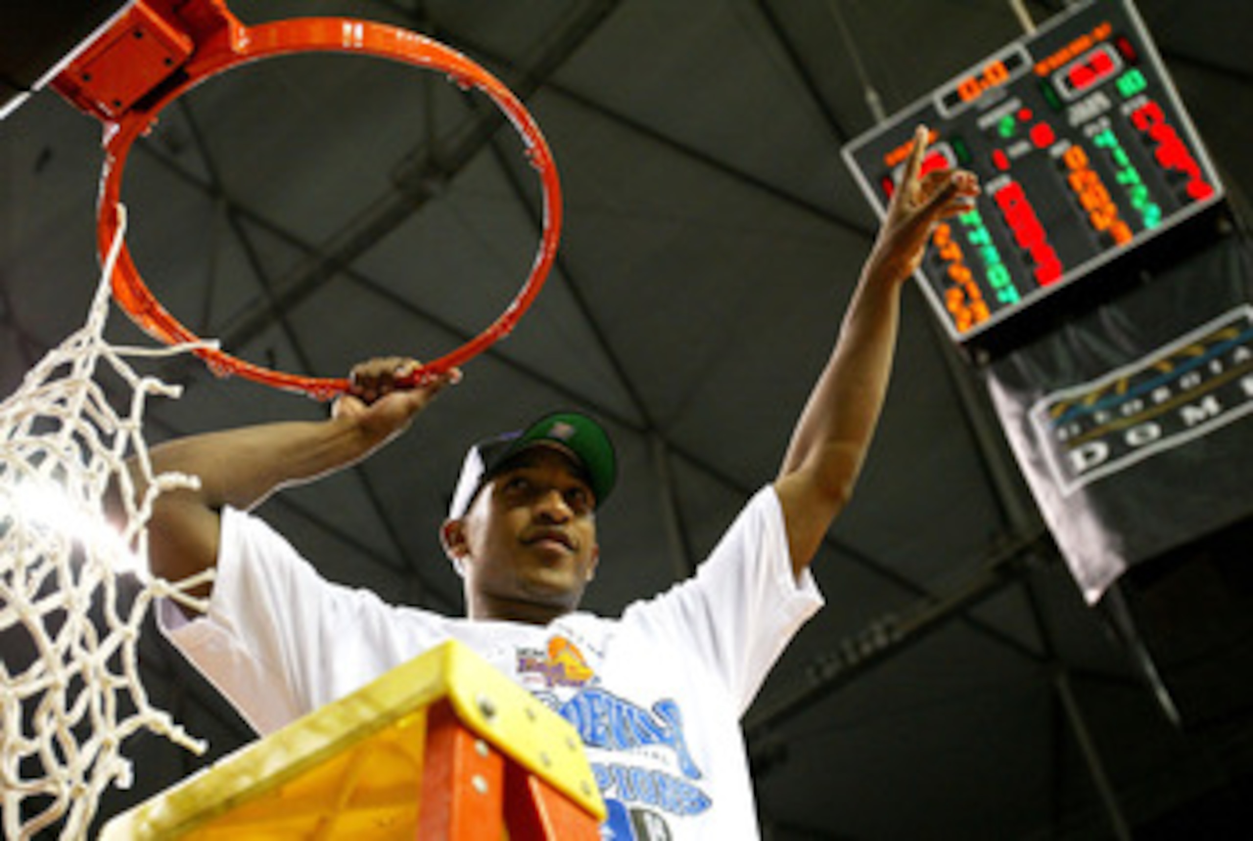ATLANTA - MARCH 28:   Chris Duhon #21 of the Duke Blue Devils cuts down the net after Duke defeated the Xavier Muskateers 66-63 to win the fourth round game of the NCAA Division I Men's Basketball Tournament at the Georgia Dome on March 28, 2004 in Atlant
