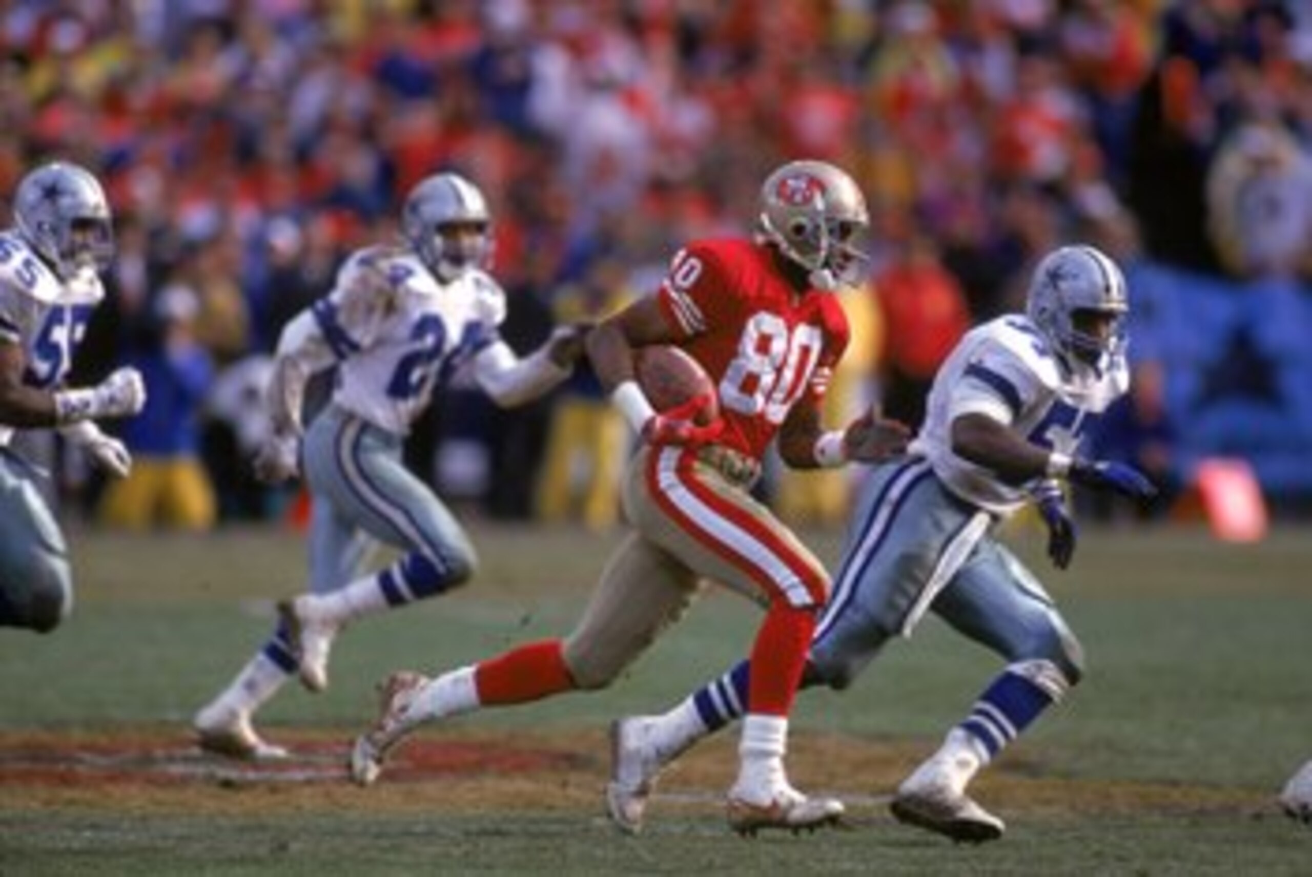 SAN FRANCISCO - JANUARY 17:  Wide receiver Jerry Rice #80 of the San Francisco 49ers finds room to run against the Dallas Cowboys defense during the 1992 NFC Championship Game at Candlestick Park on January 17, 1993 in San Francisco, California.  The Cowb