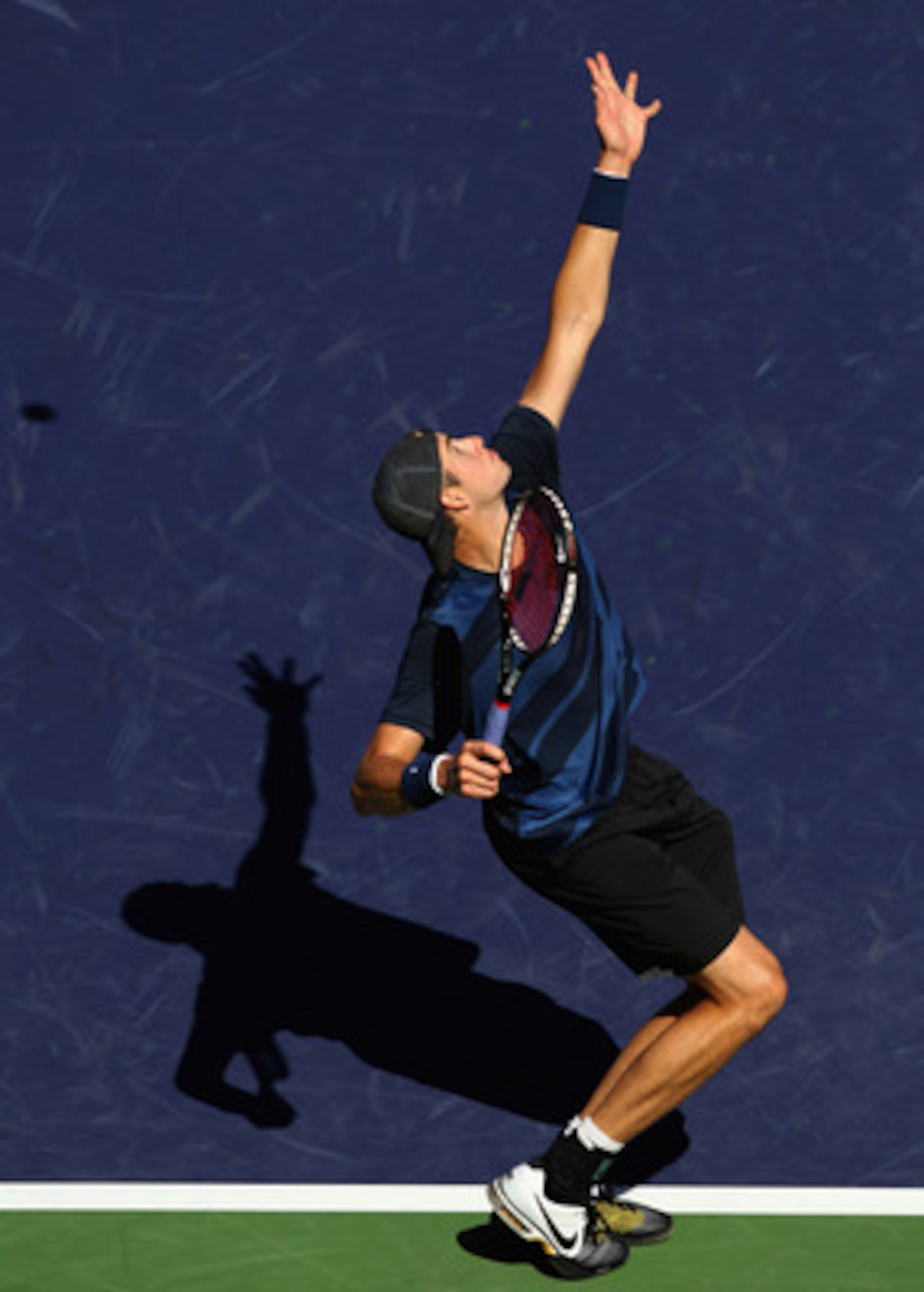 INDIAN WELLS, CA - MARCH 13:  John Isner of the USA serves to Ricardo Mello of Brazil during the BNP Paribas Open at the Indian Wells Tennis Garden on March 13, 2011 in Indian Wells, California.  (Photo by Ezra Shaw/Getty Images)