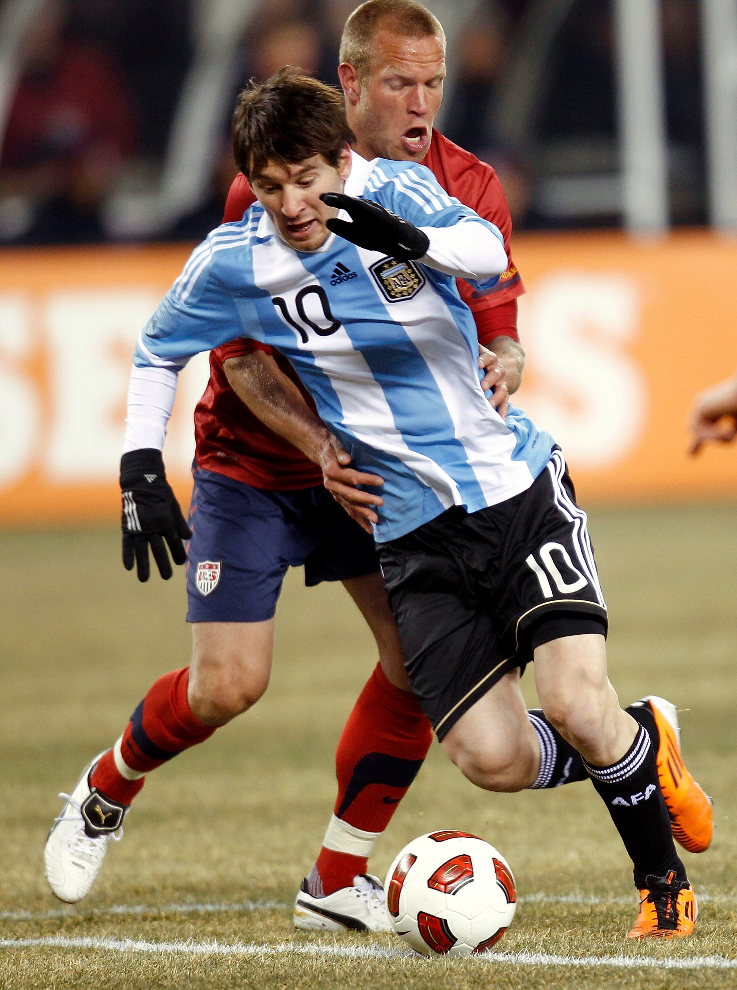 EAST RUTHERFORD, NJ - MARCH 26: Lionel Messi #10 of Argentina tries to get away from Jay DeMerit #15 of the United States during the first half of a friendly match at New Meadowlands Stadium on March 26, 2011 in East Rutherford, New Jersey. (Photo by Je EAST RUTHERFORD, NJ - MARCH 26: Lionel Messi #10 of Argentina tries to get away from Jay DeMerit #15 of the United States during the first half of a friendly match at New Meadowlands Stadium on March 26, 2011 in East Rutherford, New Jersey. (Photo by Je