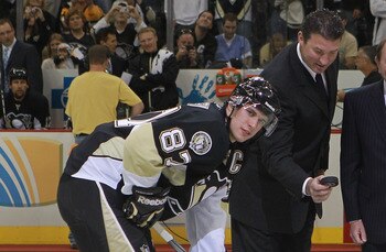 PITTSBURGH - OCTOBER 07:  Team owner Mario Lemieux of the Pittsburgh Penguins drops the puck between Sidney Crosby #87 and Mike Richards #18 of the Philadelphia Flyers as NHL commissioner Gary Bettman looks on prior to the arena opening game  at the Conso