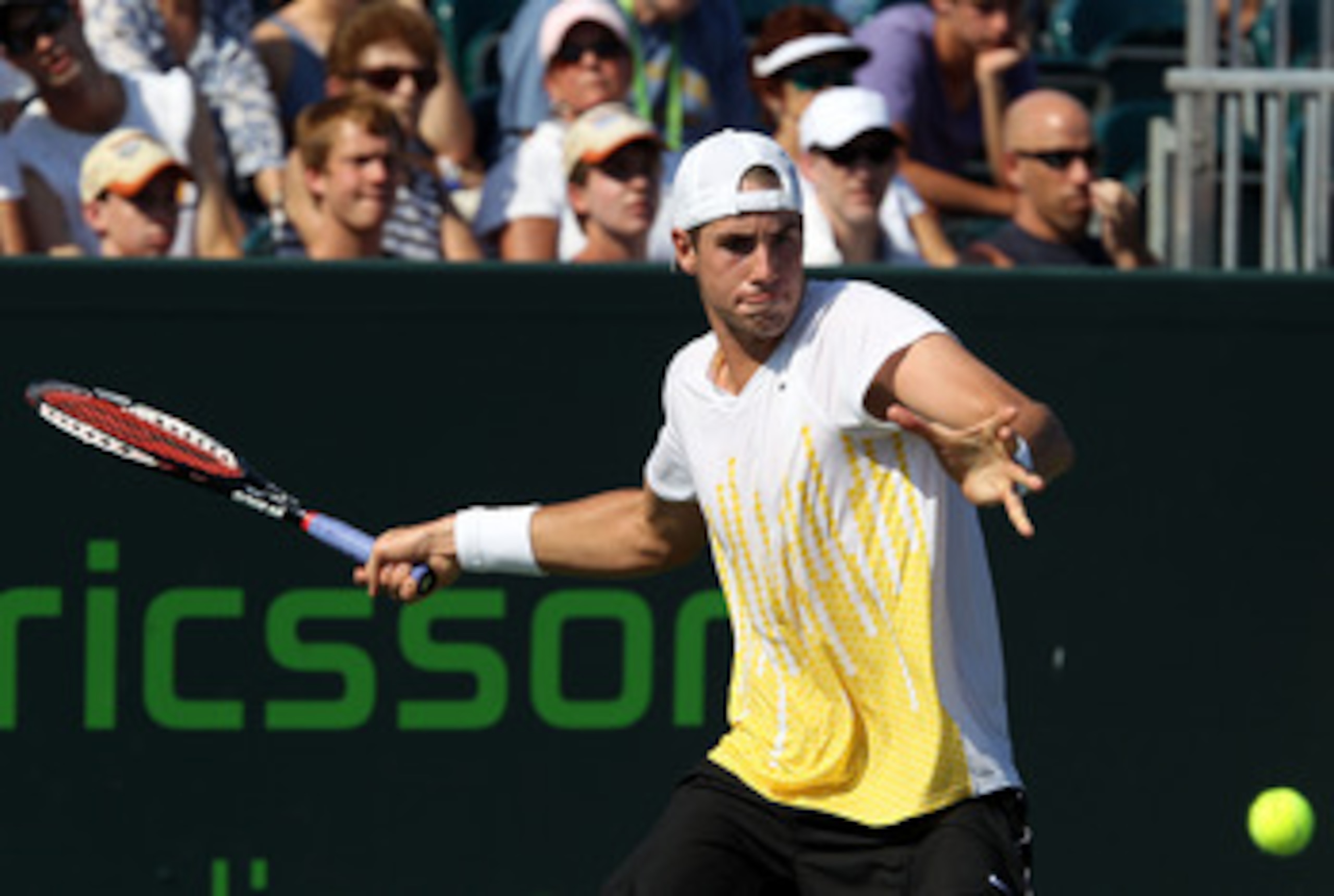 KEY BISCAYNE, FL - MARCH 27:  John Isner hits a forehand against Alex Bogomolov Jr. during the Sony Ericsson Open at Crandon Park Tennis Center on March 27, 2011 in Key Biscayne, Florida.  (Photo by Clive Brunskill/Getty Images)