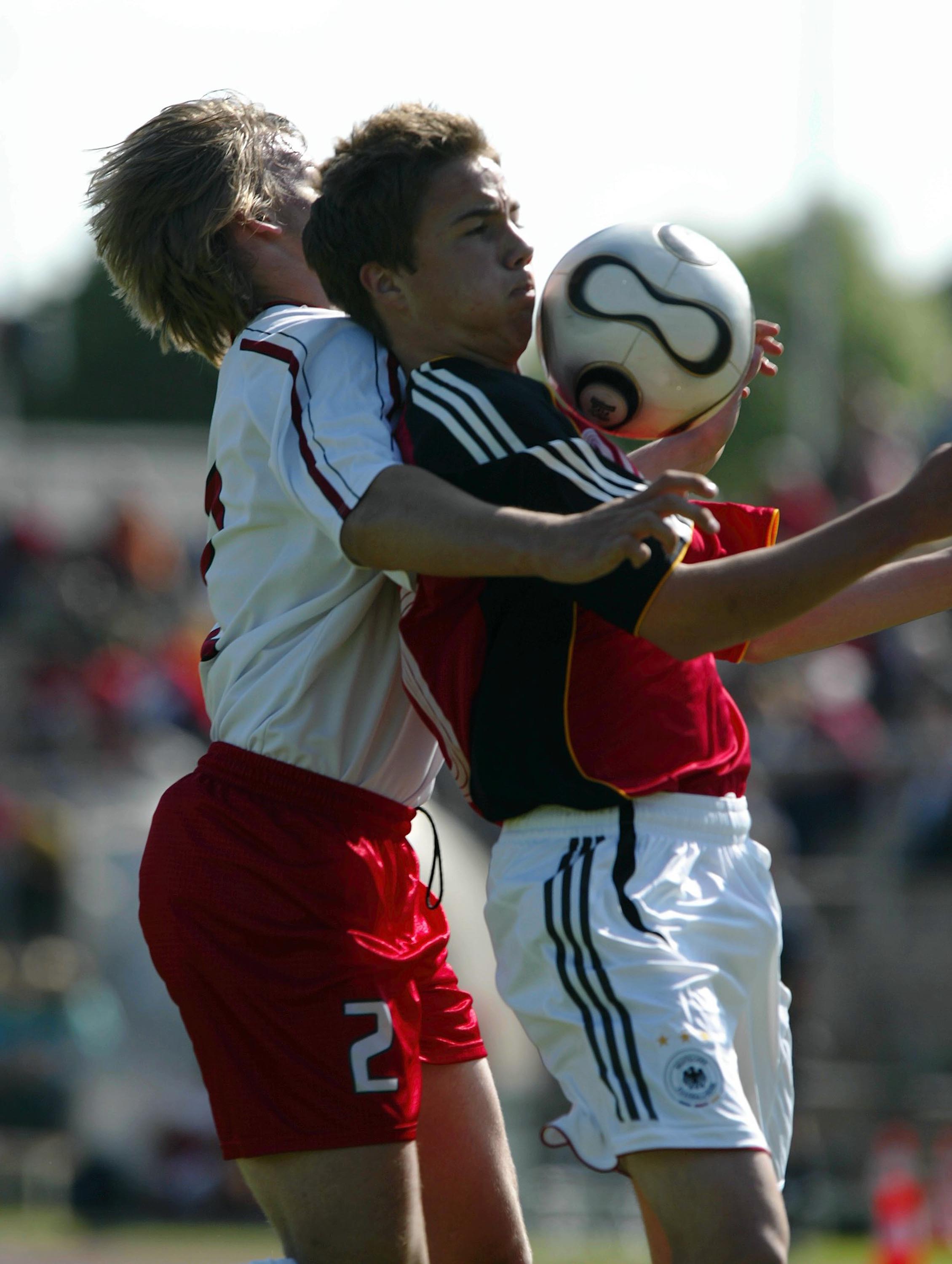 WEIMAR, GERMANY - MAY 18:  Filip Modelski (L) of Poland and Mario Goetze (R) of Germany battle for the ball during the Men's U15 friendly match between Germany and Poland at the Wimaria stadium on May 18, 2007 in Weimar, Germany. (Photo by Dirk Brzoska/Bo