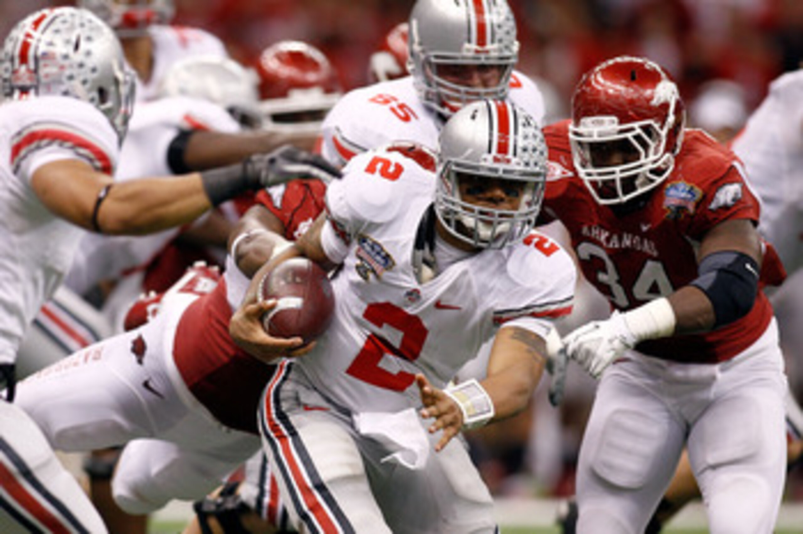 NEW ORLEANS, LA - JANUARY 04:  Quarterback Terrelle Pryor #2 of the Ohio State Buckeyes runs the ball against Jerry Franklin #34 of the Arkansas Razorbacks in the fourth quarter during the Allstate Sugar Bowl at the Louisiana Superdome on January 4, 2011