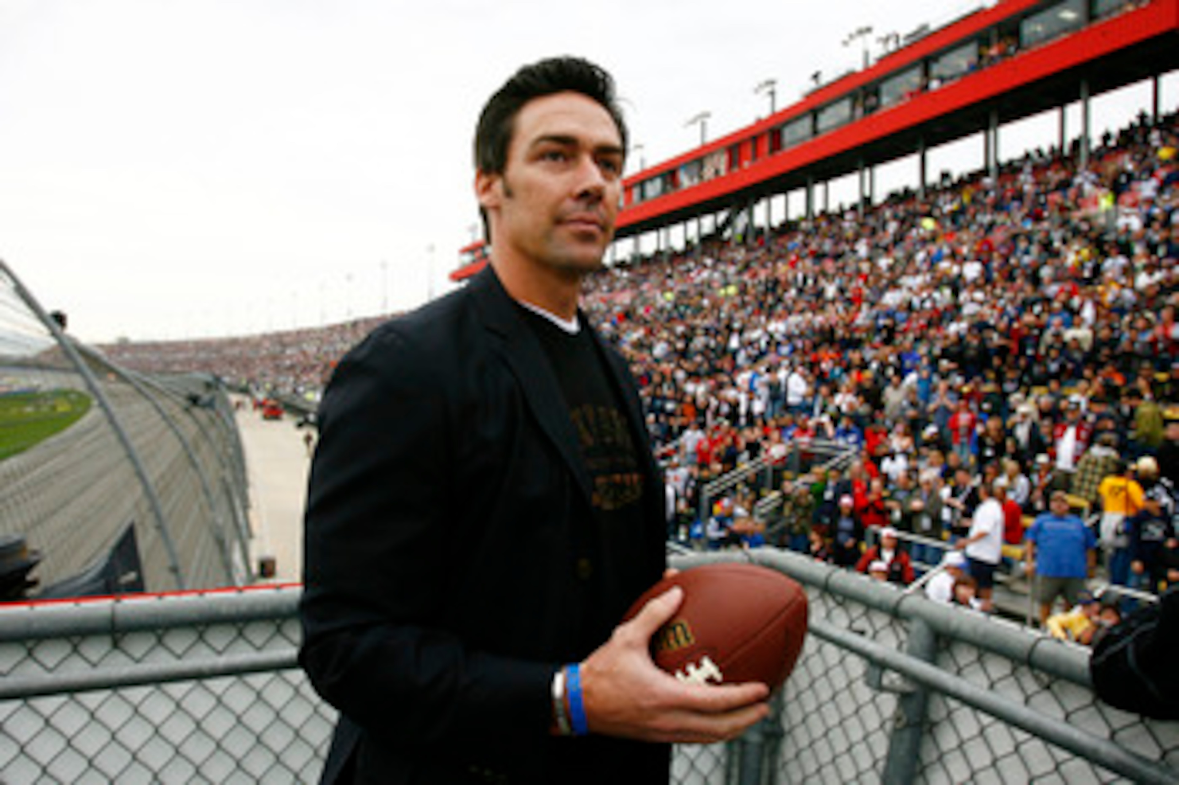 FONTANA, CA - FEBRUARY 22:  Jason Sehorn, former New York Giants football player, looks to throw an autographed football to the crowd prior to the start of the NASCAR Sprint Cup Series Auto Club 500 at Auto Club Speedway on February 22, 2009 in Fontana, C