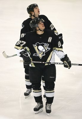 PITTSBURGH - APRIL 15:  Sidney Crosby #87 and Colby Armstrong #20 of the Pittsburgh Penguins check the overhead scoreboard during a break in game action of Game 3 against the Ottawa Senators in the 2007 Eastern Conference Quarterfinals at Mellon Arena on