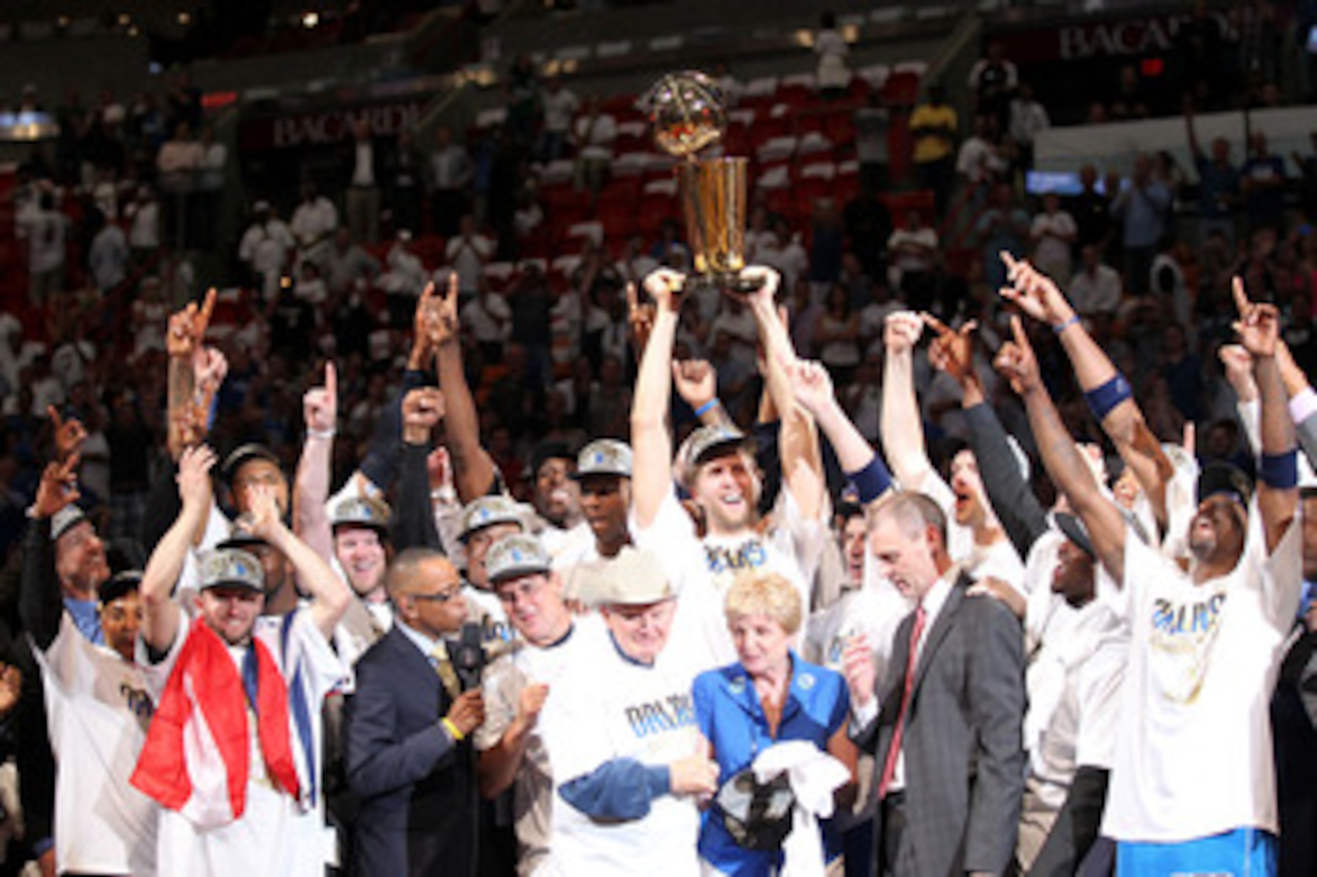 MIAMI, FL - JUNE 12:  Finals MVP Dirk Nowitzki #41 of the Dallas Mavericks celebrates with the Larry O'Brien Championship trophy along with Brendan Haywood #33, Caron Butler and team owner Mark Cuban after the Mavericks won 105-95 against the Miami Heat i