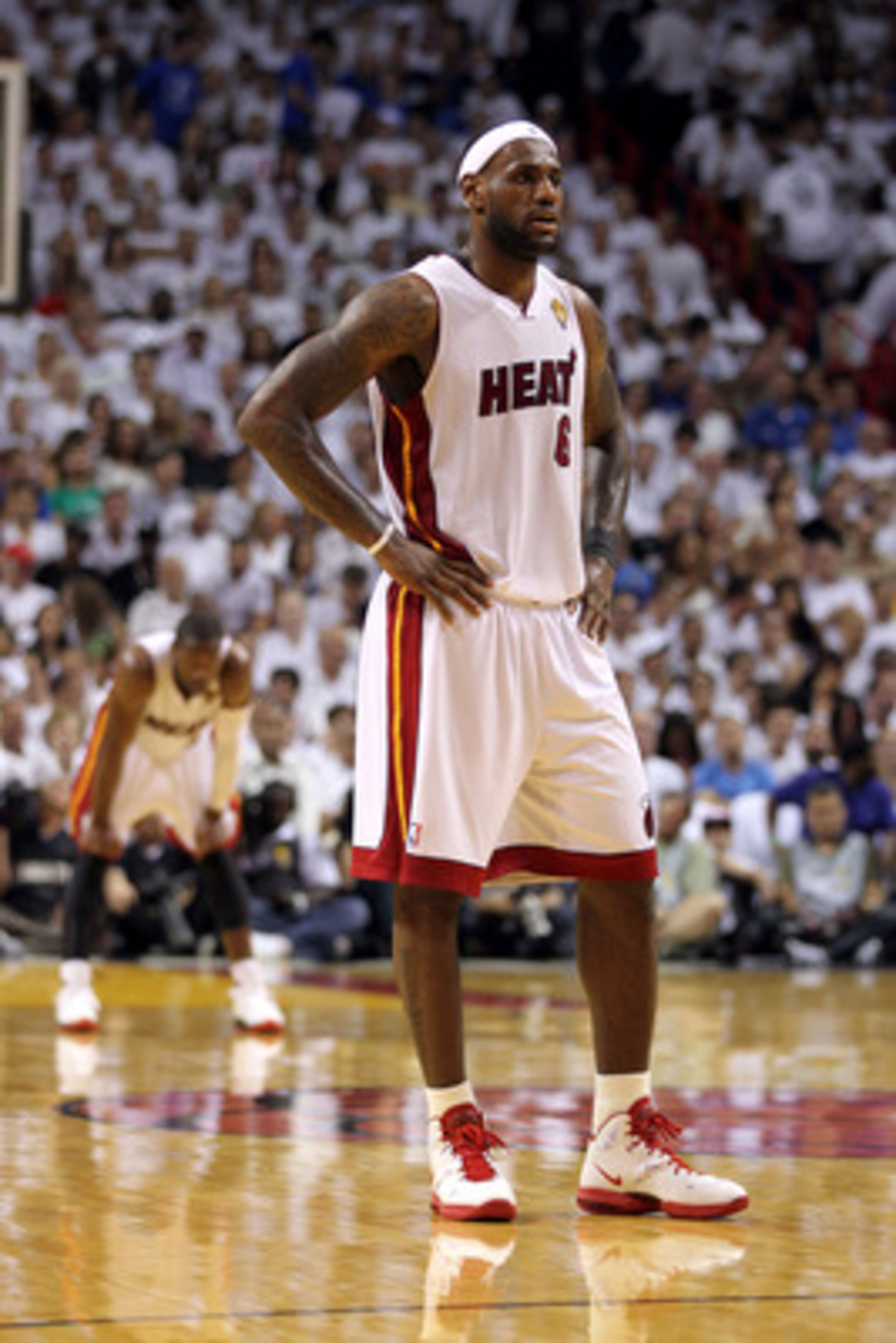 MIAMI, FL - JUNE 12:  LeBron James #6 of the Miami Heat looks on as Dwyane Wade stands in the background against the Dallas Mavericks in Game Six of the 2011 NBA Finals at American Airlines Arena on June 12, 2011 in Miami, Florida. NOTE TO USER: User expr