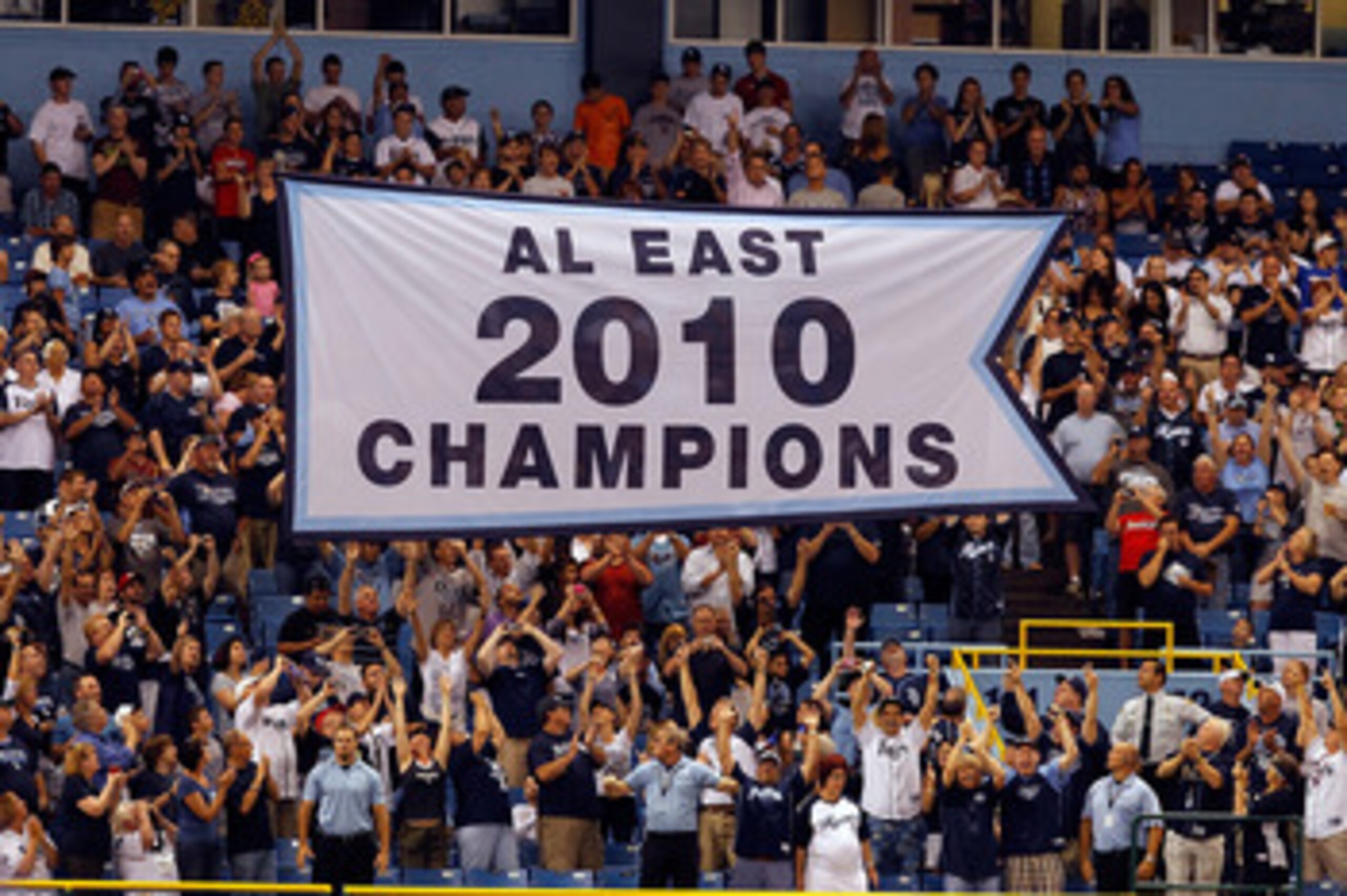 ST. PETERSBURG, FL - APRIL 01:  The Tampa Bay Rays raise their 2010 American League East championship banner just before the start of the Opening Day game against the Baltimore Orioles at Tropicana Field on April 1, 2011 in St. Petersburg, Florida.  (Phot