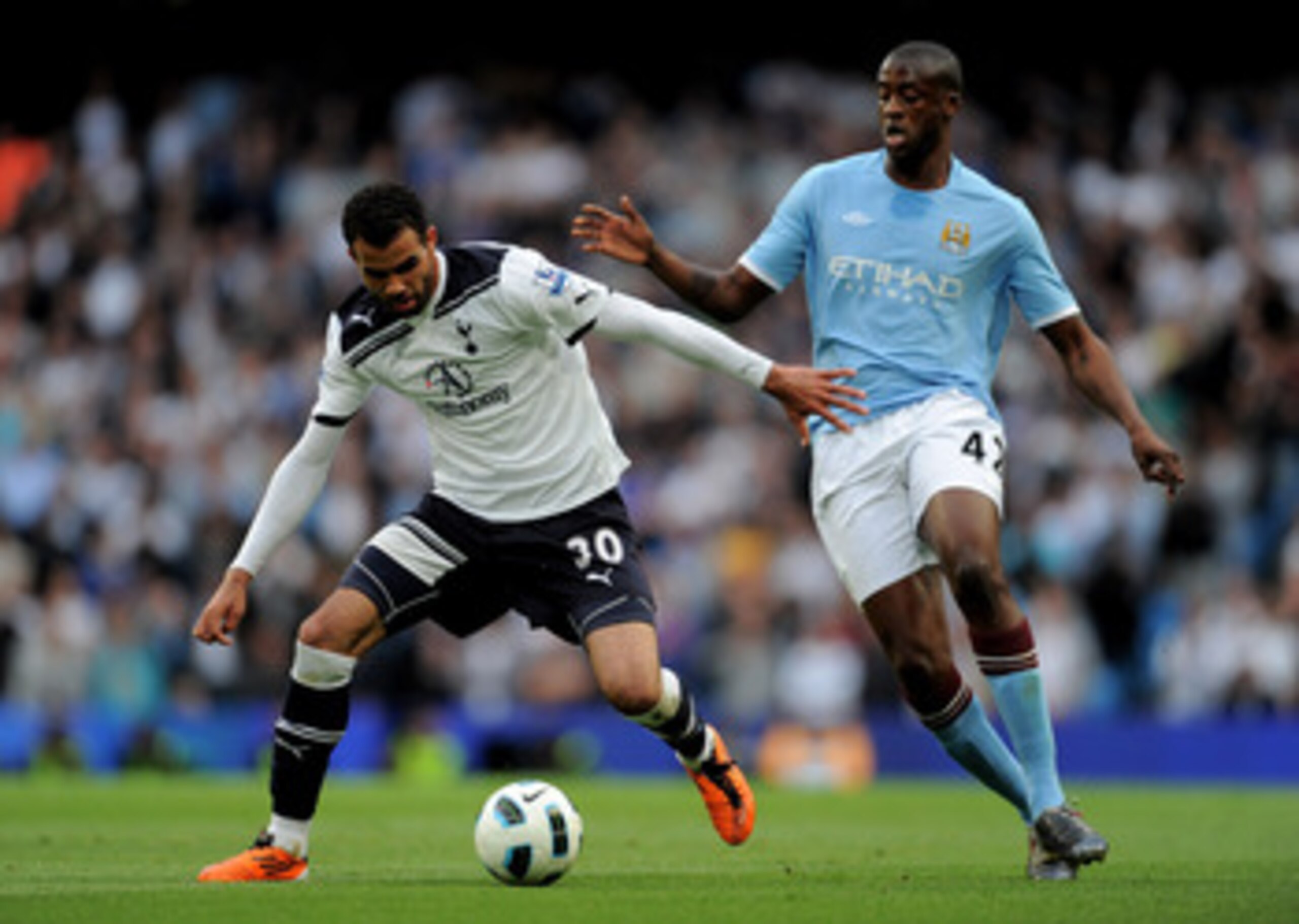 MANCHESTER, UNITED KINGDOM - MAY 10:  Sandro of Tottenham Hotspur competes with Yaya Toure of Manchester City during the Barclays Premier League match between Manchester City and Tottenham Hotspur at the City of Manchester Stadium on May 10, 2011 in Manch