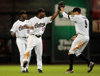 HOUSTON - AUGUST 31:  Center fielder Michael Bourn #21 and Jason Bourgeois #11 of the Houston Astros congratulate teammate Hunter Pence #9 after they defeated the St. Louis Cardinals 3-0 at Minute Maid Park on August 31, 2010 in Houston, Texas.  (Photo by