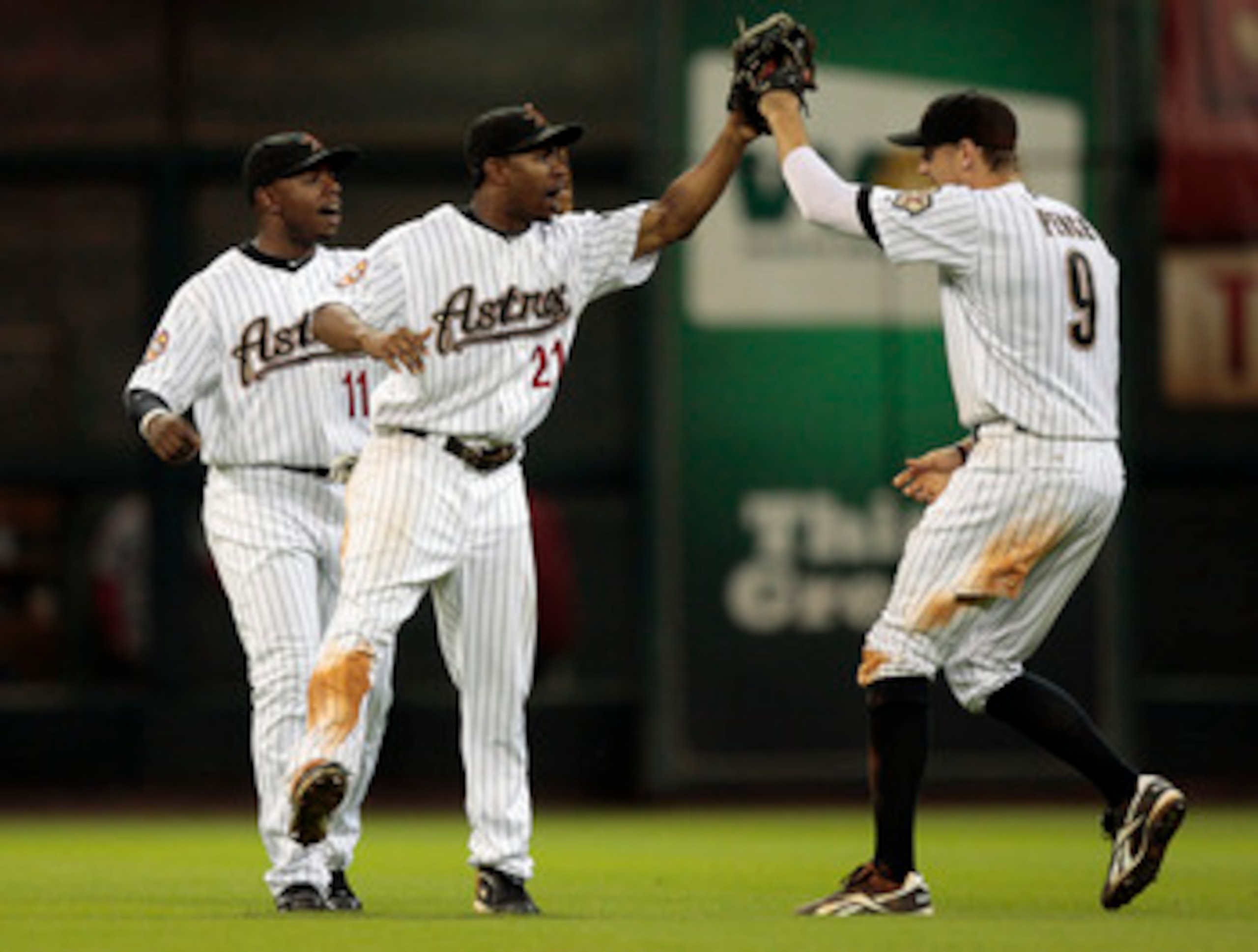 HOUSTON - AUGUST 31:  Center fielder Michael Bourn #21 and Jason Bourgeois #11 of the Houston Astros congratulate teammate Hunter Pence #9 after they defeated the St. Louis Cardinals 3-0 at Minute Maid Park on August 31, 2010 in Houston, Texas.  (Photo by