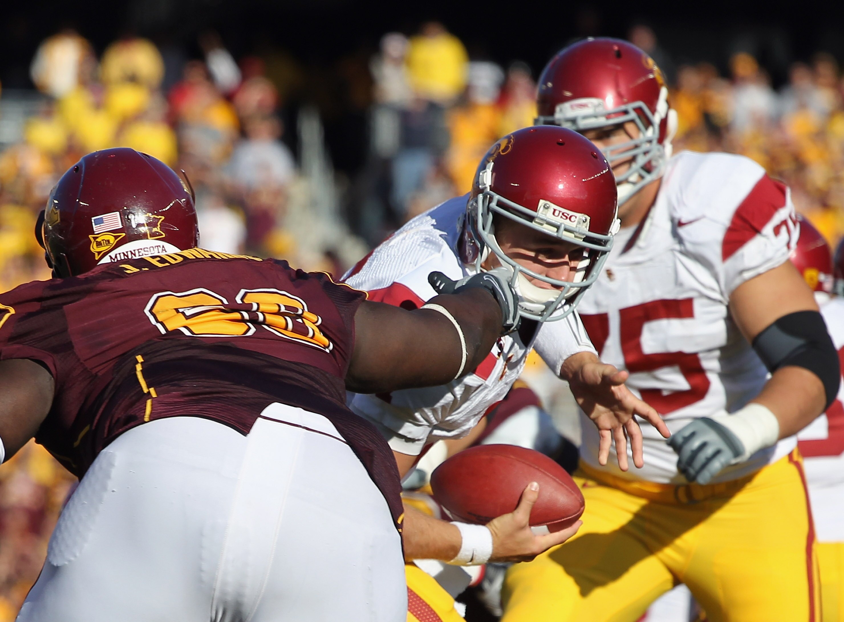 MINNEAPOLIS - SEPTEMBER 18:  Jewhan Edwards #68 of the Minnesota Golden Gophers grabs the facemask of quarterback Matt Barkley #7 of the USC Trojans during the game on September 18, 2010 at TCF Bank Stadium in Minneapolis, Minnesota.  (Photo by Jamie Squi