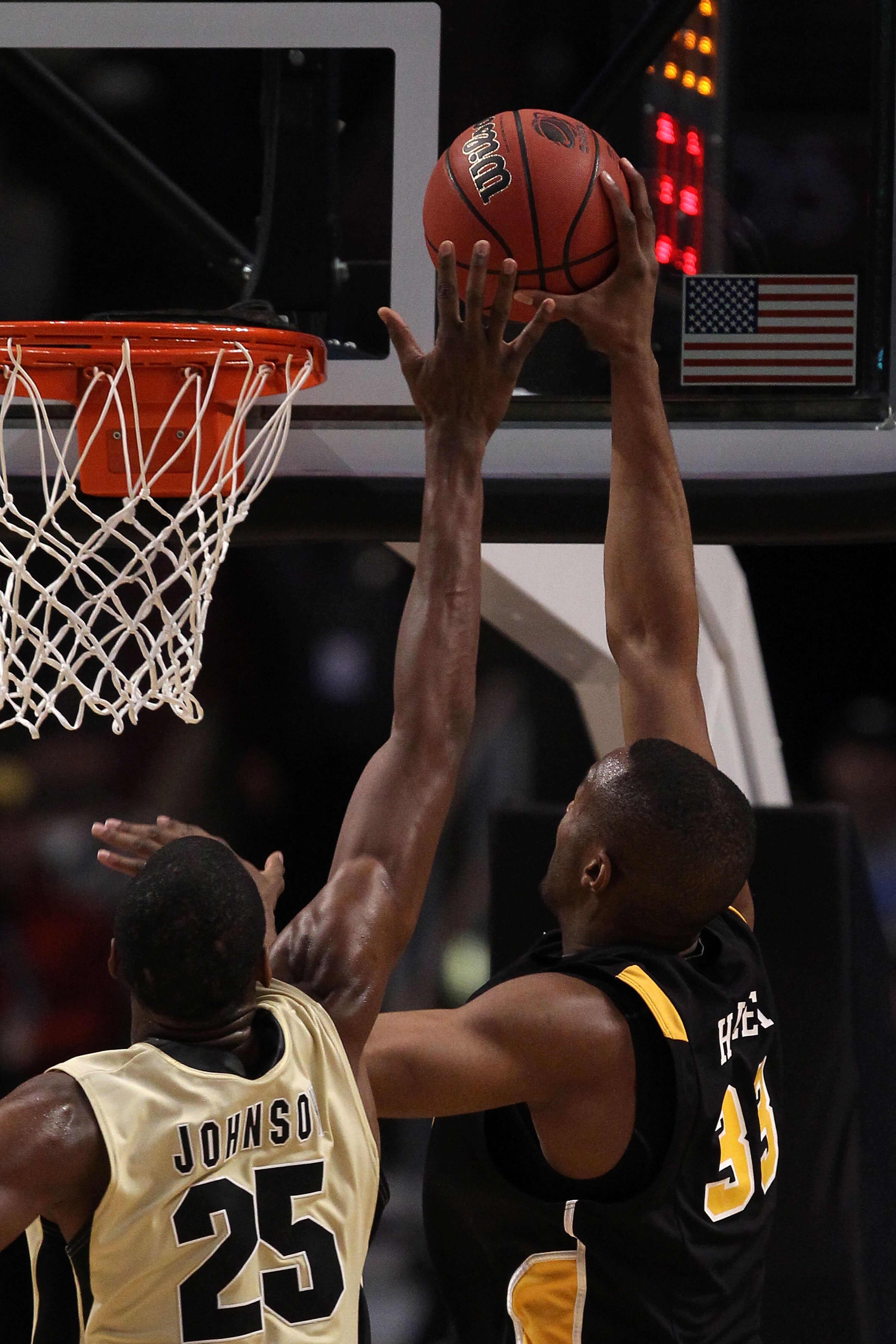 CHICAGO, IL - MARCH 20:  D.J. Haley #33 of the Virginia Commonwealth Rams shoots on JaJuan Johnson #25 of the Purdue Boilermakers n the first half during the third round of the 2011 NCAA men's basketball tournament at the United Center on March 20, 2011 i