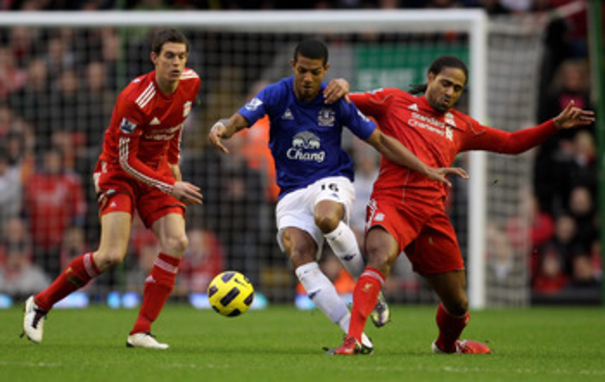 LIVERPOOL, ENGLAND - JANUARY 16:  Daniel Agger (L) and Glen Johnson of Liverpool compete with Jermaine Beckford of Everton during the Barclays Premier League match between Liverpool and Everton at Anfield on January 16, 2011 in Liverpool, England.  (Photo