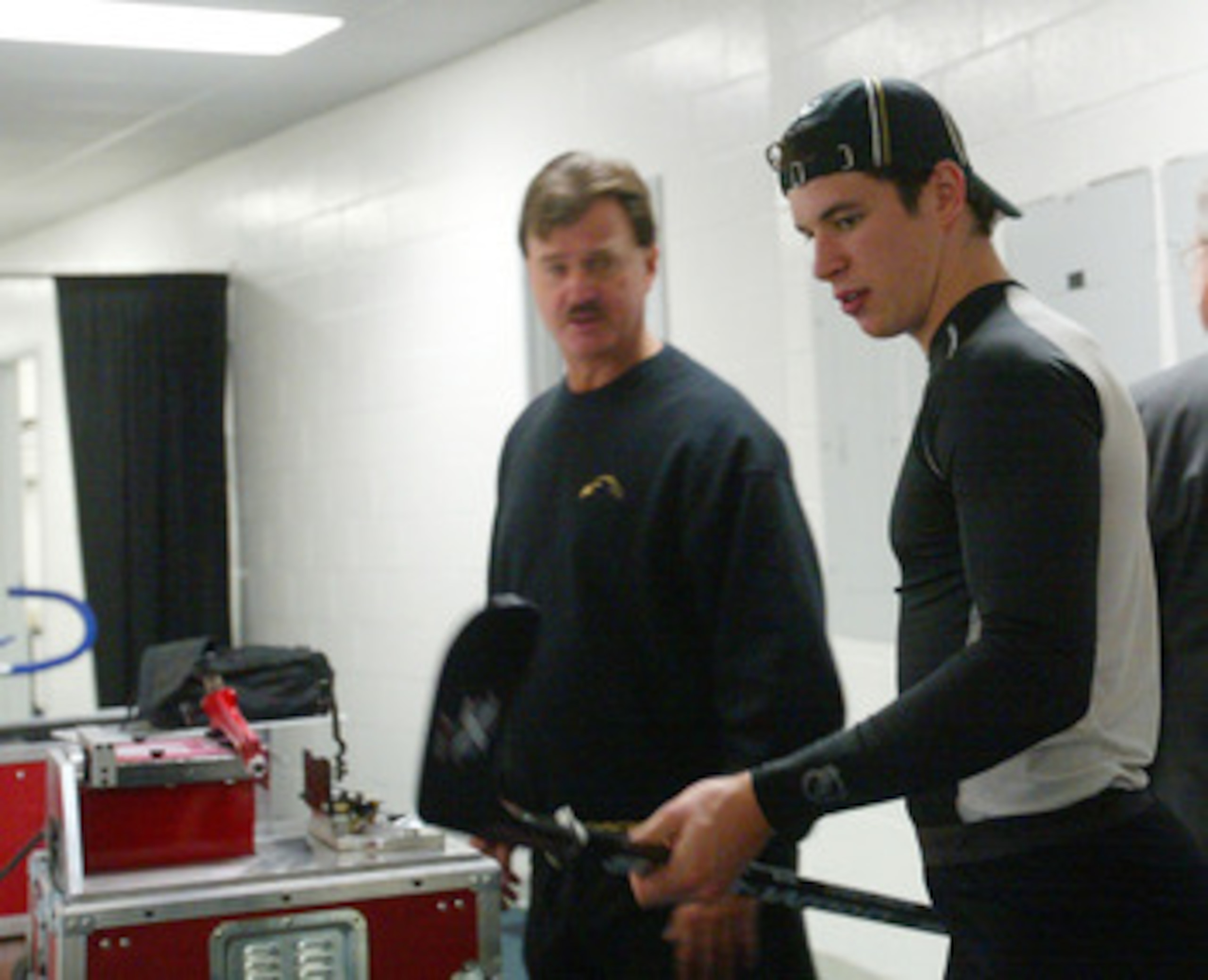 EAST RUTHERFORD, NJ - OCTOBER 5: Sidney Crosby #87 (R) and trainer Steve Latin (L) of the Pittsburgh Penguins prepare Crosby's equipment for his first NHL game against the New Jersey Devils on October 5, 2005 at Continental Airlines Arena in East Rutherf EAST RUTHERFORD, NJ - OCTOBER 5: Sidney Crosby #87 (R) and trainer Steve Latin (L) of the Pittsburgh Penguins prepare Crosby's equipment for his first NHL game against the New Jersey Devils on October 5, 2005 at Continental Airlines Arena in East Rutherf