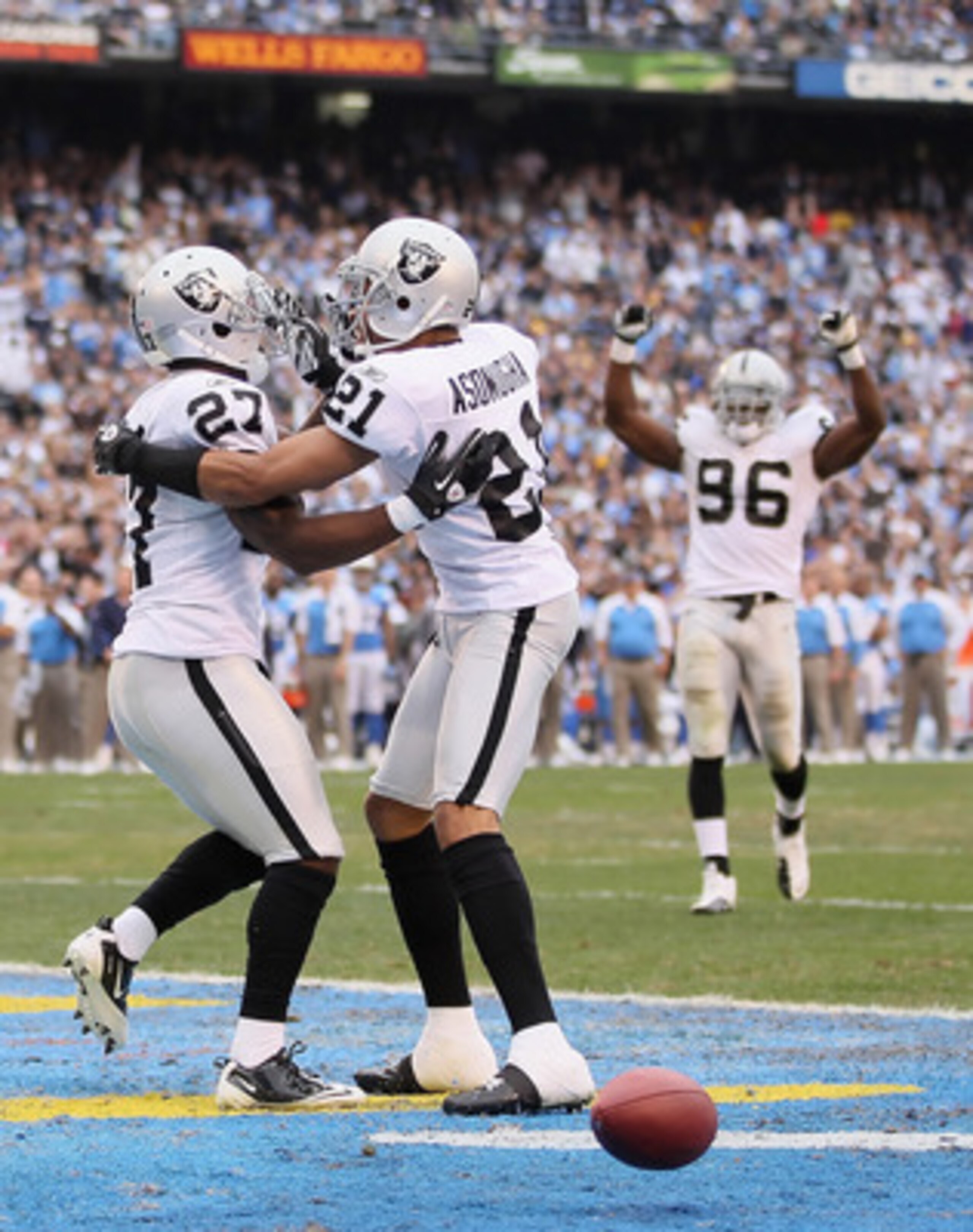 SAN DIEGO - DECEMBER 05:  (L-R) Wide receiver Malcolm Floyd #80 of the San Diego Chargers looks down, as Stevie Brown #27 and Nnamdi Asomugha #21 the Oakland Raiders celebrate a broken play in the third quarter at Qualcomm Stadium on December 5, 2010 in S