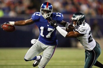 EAST RUTHERFORD, NJ - SEPTEMBER 30:  William James #21 of the Philadelphia Eagles tries to take down Plaxico Burress #17 of the New York Giants at Giants Stadium on September 30, 2007 in East Rutherford, New Jersey.  (Photo by Nick Laham/Getty Images)